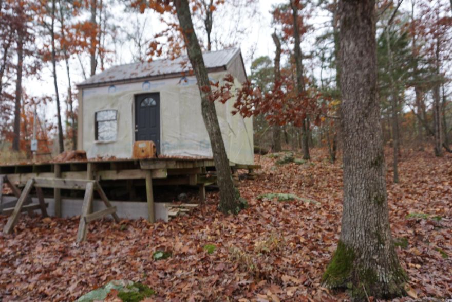 Cabin in the woods not far from town. About 37 acres on the side with the cabin and about 7 acres on the other side of the road. The cabin is up in the dry and you can finish it out how you want. Beautiful views and plenty of room to build on or to hunt or just simply get away off the grid !