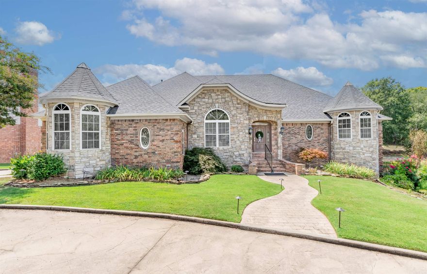 Welcome to this gorgeous home with a circle front drive that features 2 main bedrooms on main floor along with family room, formal dining, laundry and a beautiful eat in kitchen area.  Kitchen features great cabinet storage, granite counters, breakfast bar, view of pool and pond, double ovens and so much more.  There are covered patios over looking the pool and ponds.  Downstairs you will find 2 bedrooms, full bath, another laundry, game room area with a fireplace, office area-that could be the 5th bedroom- that leads to a walk in basement area with shelving.  The gym (converted garage) is heated and cooled, approx 354 SF not included in tax records. That room also has storage cabinets and a sink.  Doors off all rooms downstairs leads to the pool.  Home features whole house generator, solar panels and a room they use during storms.  There is also an office area off the garage so be sure not to miss that-has a 1/2 bath as well.  Home was custom built and there is beautiful crown molding and lots of added features. Agents see associated documents for ALL the upgrades seller has done to maintain this beautiful home.