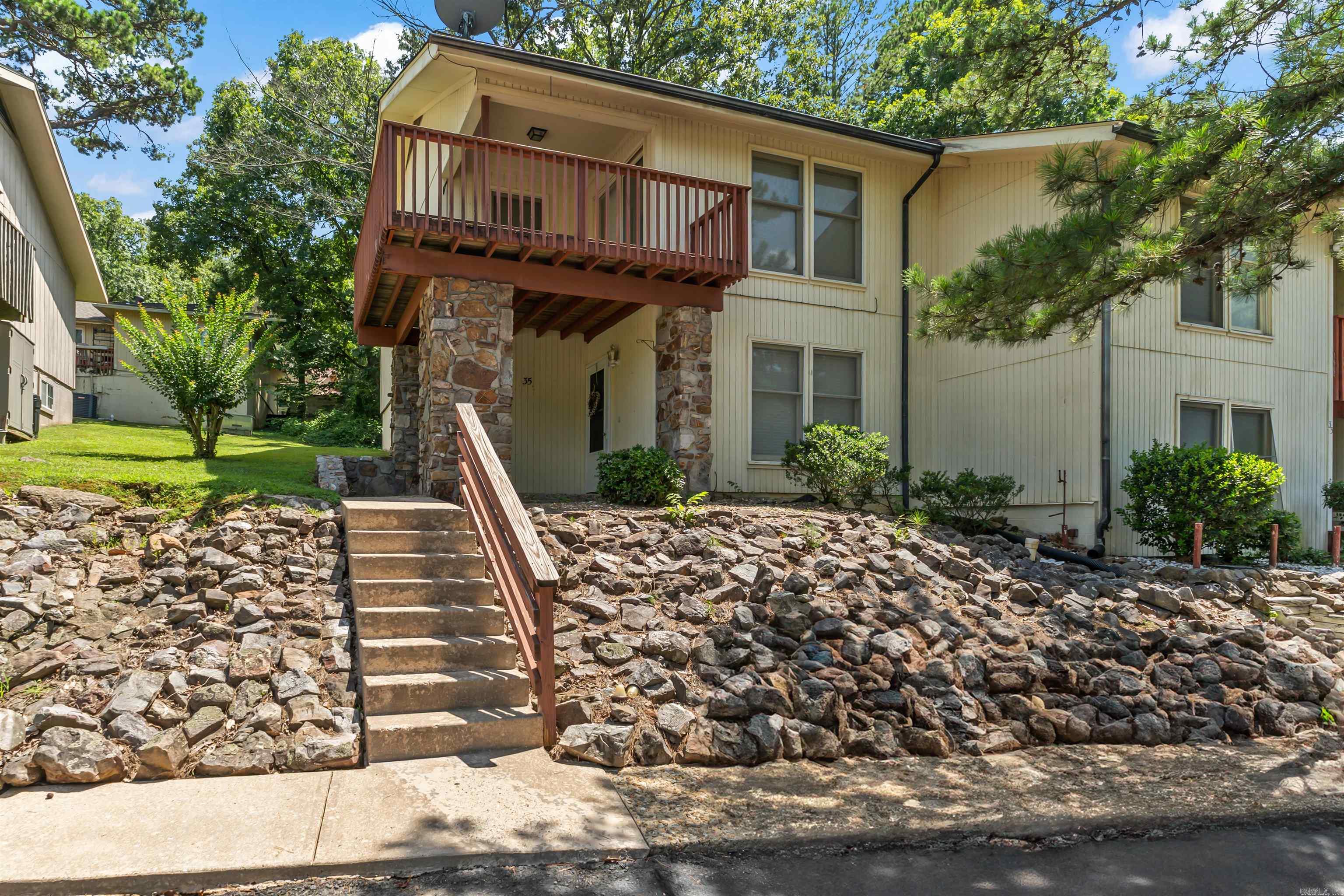 Charming and spacious townhome offers comfort, convenience and character in the heart of Hot Springs Village. Featuring 3 roomy bedrooms and 2 baths with updated counters and tiled shower/bath enclosures. The main level includes a cozy living room, dining area, a cute kitchen with newer appliances, a full bath, and a bedroom - perfect for guests or a home office. Upstairs, you'll find a versatile loft, two additional bedrooms, and a second full bath. Enjoy morning coffee or unwind in the evenings on the generous upstairs balcony - ideal for plants, stretching out, or simply relaxing. Conveniently located near the West Gate, you are just minutes from shopping, medical facilities and all the top-notch amenities HSV has to offer.