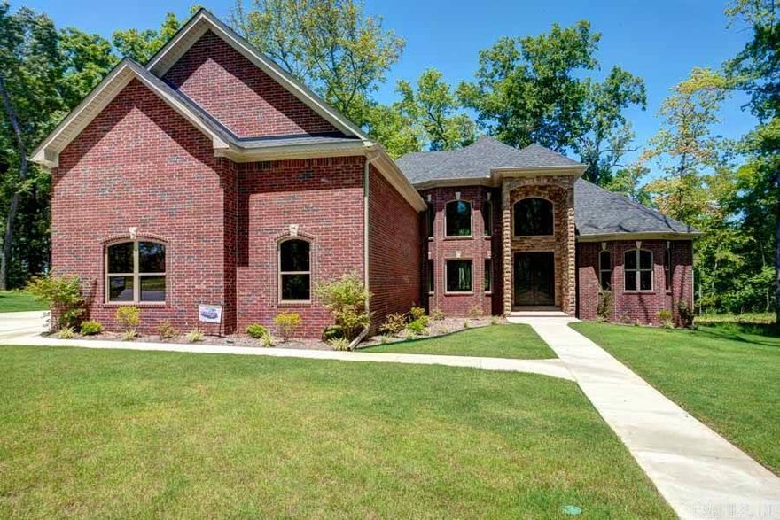 Permanent private green space with view of Pinnacle Mountain. New construction with extensive trim detail. Versatile floor plan w/10' ceilings. 5" scraped hardwoods, iron front door, cathedral ceilings- lives like a one level. Chef's kitchen has island, 5 gas burner, double oven, seating area and open to den. Split master w/spa-like master bath with rainhead shower and large closet. Cozy covered patio w/ fireplace- wired for cable. Fast recovery HWHs, surround sound and 4 car garage. Elegant & private.