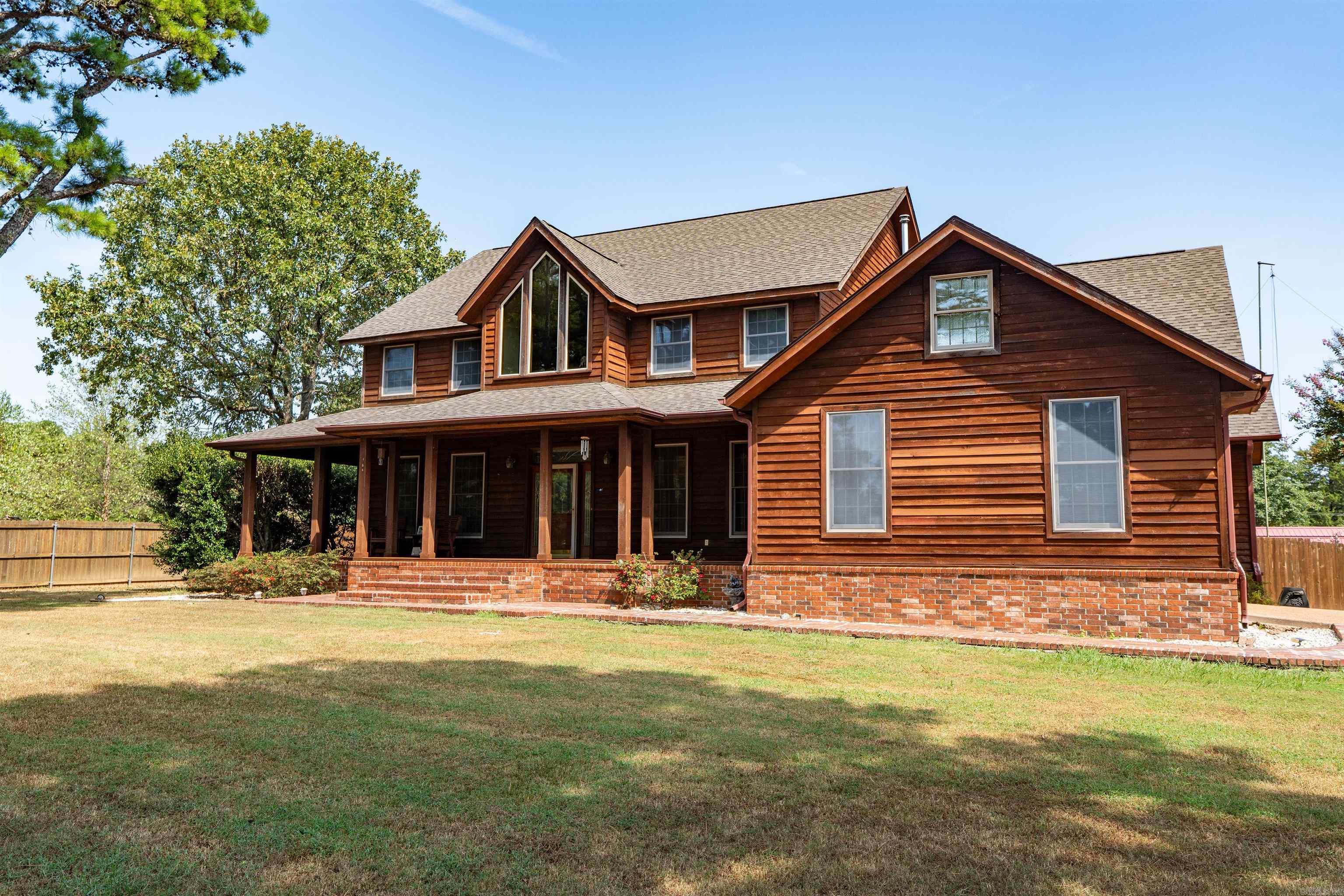 This beautiful home is a must see! Setting on 1.80 acres. Home has a new high resistant roof, it is the best for wind hail. Open floor plan, eat in kitchen with lots of windows. Half bath downstairs. also downstairs has large Master bedroom walk-in closet a large master bath with granite throughout, walk in shower, double vanity, large jacuzzi tub. Home has a large laundry room with lots of storge. Upstairs has 3 bedrooms full bath. Home has an additional 275 sq. feet room that could be used as an office. The home has a pellet stove. Two car garage, large porch on front and back. Property has raised garden beds a storage building and extra parking.