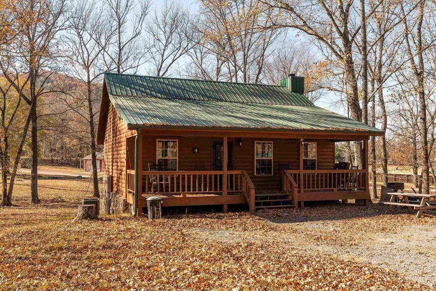 Charming 2-Bedroom Log Cabin Near Little Red River.   Nestled in a serene and picturesque setting, this cozy 2-bedroom, 1-bath log cabin offers the perfect retreat for those seeking a peaceful getaway. With its rustic charm and vaulted wood ceilings, the cabin exudes warmth and character throughout. The spacious living area is ideal for relaxing after a day of outdoor adventures, and large windows bring in natural light and beautiful views of the surrounding woods.  Just a short walk to the tranquil Little Red River, you'll have easy access to world-class fishing, kayaking, and peaceful riverside walks. Whether you’re looking to unwind in nature or explore the area’s outdoor offerings, this cabin provides the perfect home base.