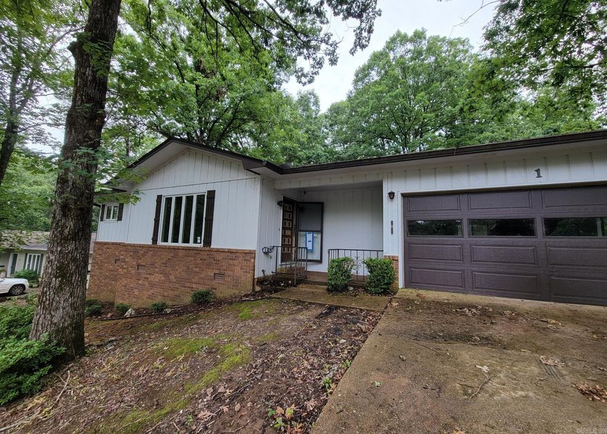 Affordable gem right by Lake DeSoto in Hot Springs Village! With some updates and TLC, this solid-structure home will be a fantastic investment. Enjoy the large 2-car garage with built in workbench, the easy-access laundry room and spacious kitchen. And that Arkansas sunroom? Perfect for all seasons as a heated/cooled space, just off the kitchen and dining area. Agents, please see remarks.