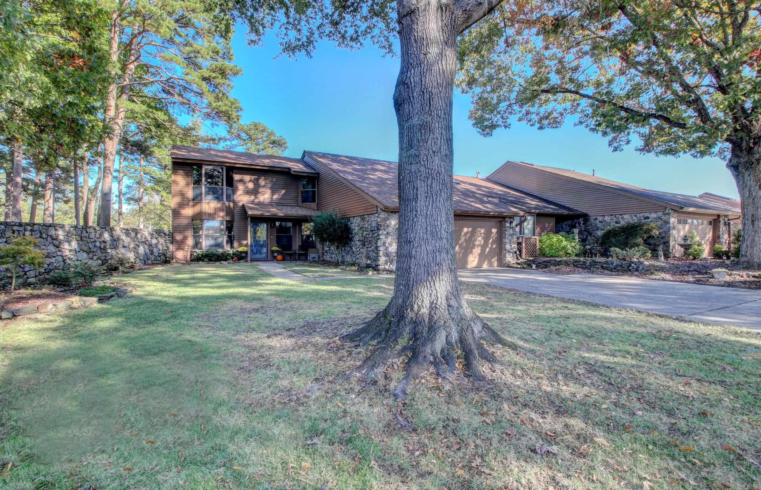 Don't miss out on this beautiful updated town home positioned perfectly overlooking the #6 tee box at the Maumelle Country Club.  This rare gem offers 3 spacious bedrooms and 2 full baths with tons of storage, a Huge living area with a grand Stone fireplace and wet bar leading out to an outdoor oasis with it's covered back porch overlooking the beautiful golf course. New Granite Kitchen and bathroom countertops. New light fixtures throughout. New LVP on stairs and throughout the upstairs. Primary bedroom and bath on ground level. Newly replaced furnace  downstairs in 2022 and New garage door opener in its spacious 2 car garage.  These homes don't come on the market often, schedule your tour NOW!!
