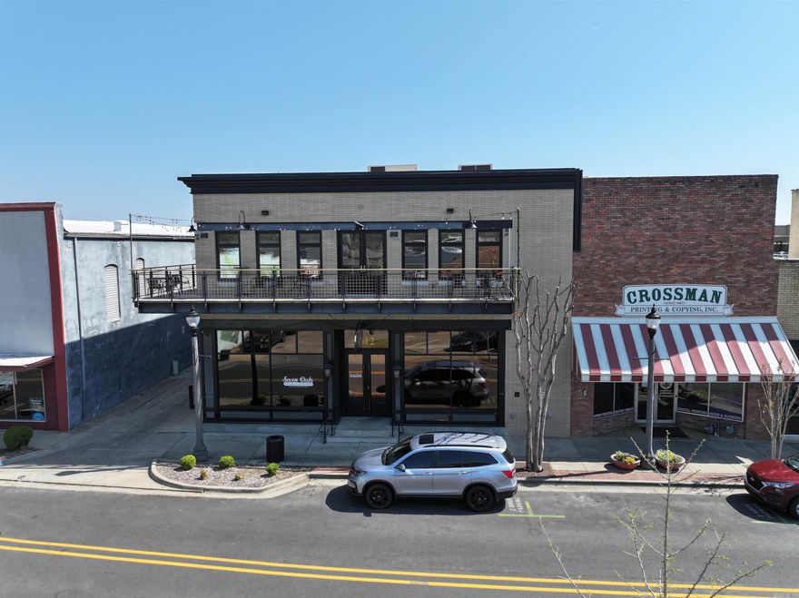 Iconic two-story landmark property with prominent signage and strong street presence along Front Street in Conway, offering a fully leased, mixed-use investment with stable in-place income. The asset features a Class A turnkey restaurant and bar with FF&E included, highlighted by a second-floor full-service bar, private event space, and ±1,000 SF balcony patio overlooking Front Street, currently occupied by Seven Oaks Steak and Seafood. The property also includes four Class A apartments with modern finishes, delivering strong residential appeal and diversified revenue streams from restaurant operations, event space, balcony seating, and luxury units. Situated in the heart of downtown Conway’s Entertainment District, the property benefits from high foot traffic, surrounding retail and nightlife, and year-round events, all within one of Arkansas’ fastest-growing markets driven by population growth, university presence, and ongoing downtown reinvestment.