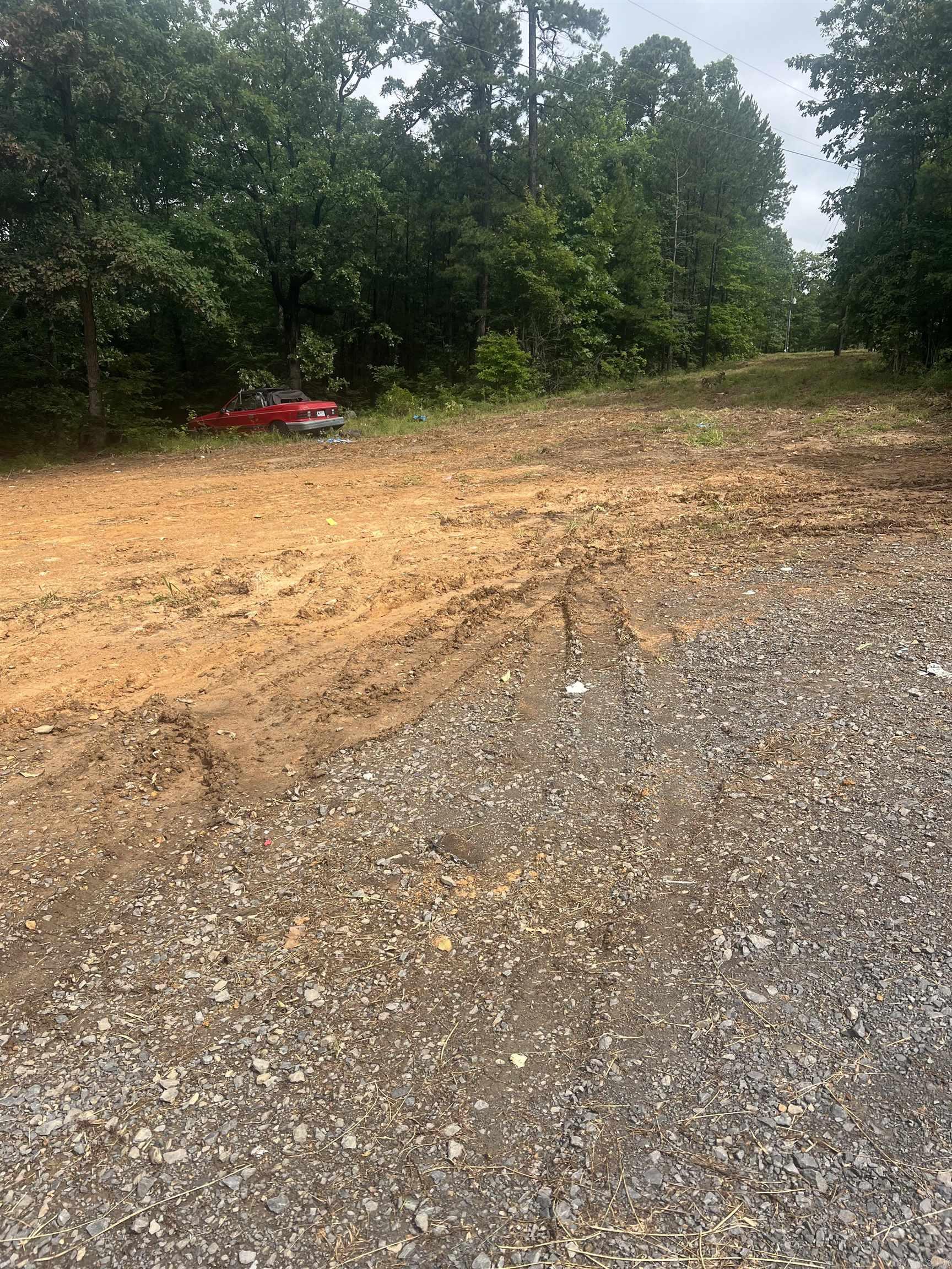 Rural tract of land on well maintained county road. Electricity and water meter on property and fiber internet available. No restrictions. RV's and Mobile Homes allowed. Partially finished tiny home conveys with the land.