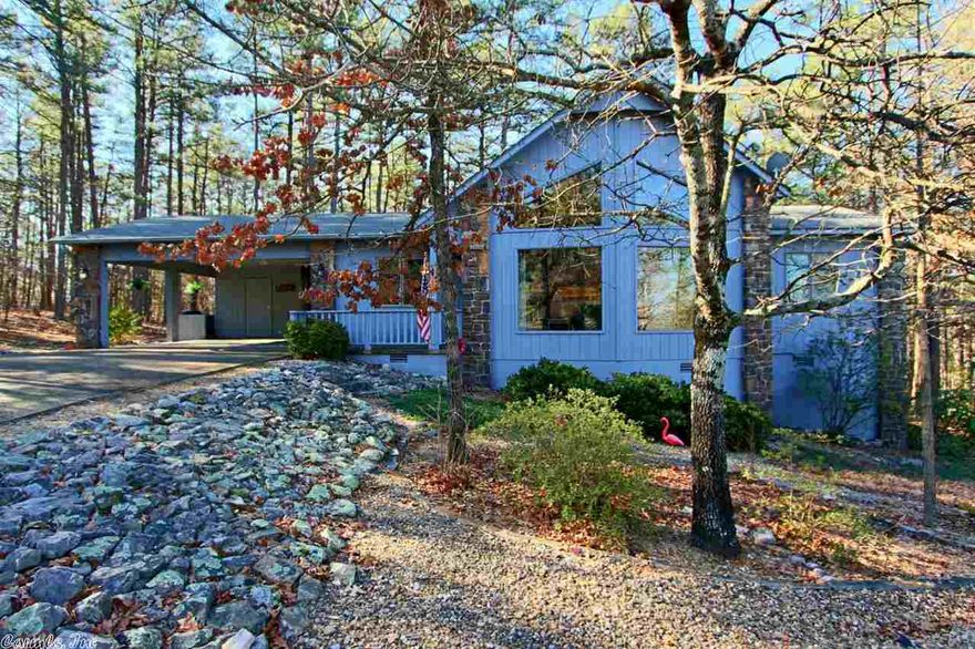 PERFECT OPTION TO A TOWNHOME. 2 BEDROOM AND 2 FULL BATHS, DOUBLE CARPORT AND ALL ON ONE LEVEL....... SPLIT BEDROOM FLOOR PLAN WITH VAULTED CATHEDRAL WINDOWS TO VIEW ALL OF NATURE'S BEAUTY. BONUS ARKANSAS ROOM OVERLOOKS COMMON PROPERTY WOODS. TIP TOP CONDITION WITH EVERYTHING ALREADY DONE. LAMINATE "TILE" LOOK FLOORING AND CARPET. WOOD BURNING FIREPLACE. BOTH BATHS FEATURE STEP IN SHOWERS. NICE QUALITY OPEN DECK  WITH FUSS FREE LANDSCAPING. LEVEL DRIVE AND JUST A COUPLE MILES FROM THE WEST GATE AMENITIES.