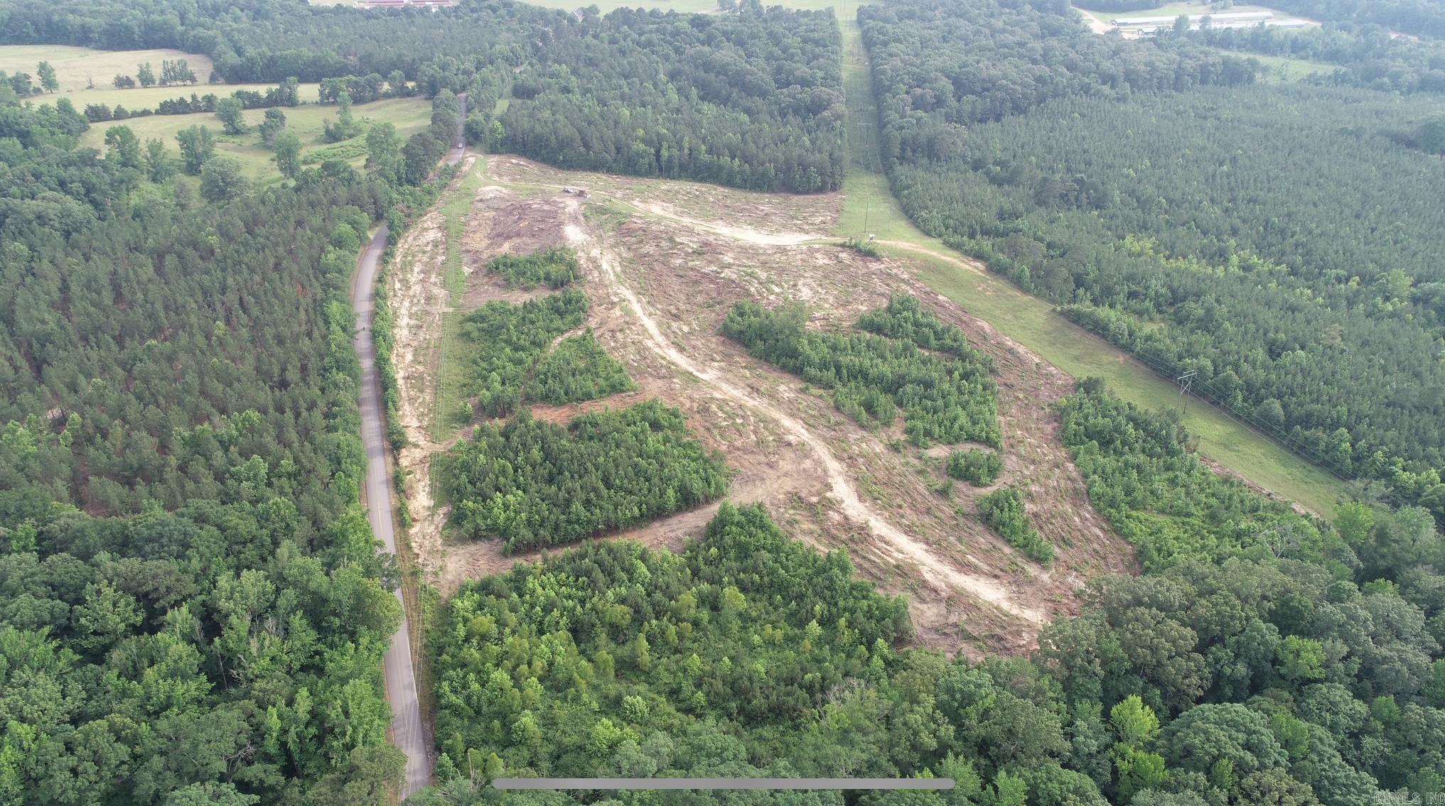 This recently cleared land is now available for homesites. Tract 2 is approximately 6 acres and offers multiple spots to build a home in a private country setting that is only 2 miles from the Main Street of Dierks, Ar. Water and electricity are available along the highway. Sellers are open to various changes in the size and dimensions of the lot. Take a look and let's talk about what meets your needs.