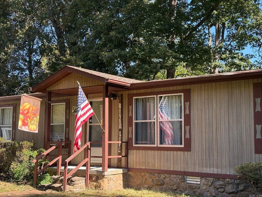 RIVERFRONT RETREAT ON THE LITTLE RED! Enjoy peaceful riverfront living in this charming 3 bedroom, 2 bath mobile home nestled along the beautiful Little Red River in Heber Springs. Move-in ready and perfectly set up for fishing and relaxation, this home features a screened-in porch overlooking the river, brand new wood stairs and a rebuilt covered dock complete with a boat lift/hoist, sink, storage and even a fishing boat included! The property is neat and clean, offering plenty of convenience with a storage building and a storm shelter. Whether you are looking for a weekend getaway or a full-time river retreat, this spot has everything you need to start enjoying river life immediately.