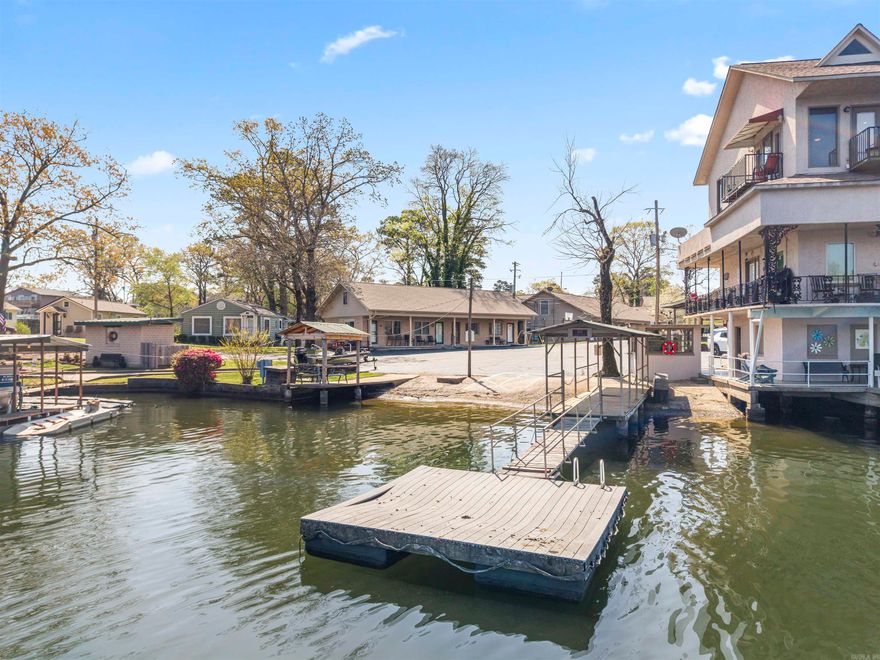 LAKELAND LODGE — YOUR LAKE LIFE STARTS HERE!  Covered boat slip, lake views, and everything you need for a weekend on the water — at a price that actually makes sense.  Your private covered slip is steps from the unit, right next to the boat ramp. Launch at sunrise, fish all day, pull back in without the hassle. The unit looks directly out over the lake and ramp, and the kitchen window frames a lake view too.  Spend time out on the point near the cove — one of the most beautiful spots on one of the most beautiful lakes in Arkansas. Cool off in the outdoor pool, hit the swim dock, or use the fully equipped owners' clubhouse. This place works for all ages — anglers, young families, boaters, anyone who wants to unplug and get on the water.  Brand new roof with attic space and pull-down stairs — a major upgrade from the old flat roof. Dedicated storage unit next to the lodge included. Ice machine on-site for common use. Comes furnished or unfurnished. Three-unit complex. Quiet. Come see it.