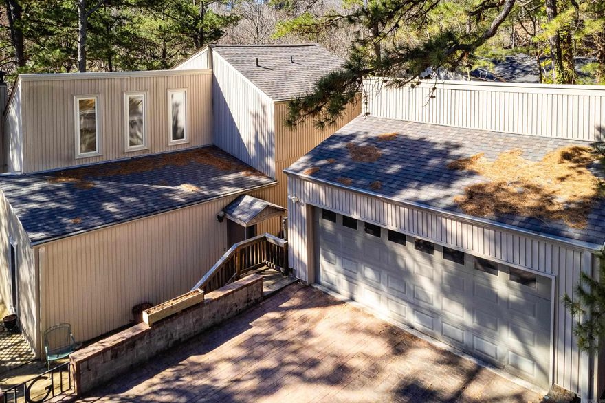 Tucked among the trees on nearly an acre, this one-of-a-kind home feels like a Colorado mountain cabin, complete with vaulted ceilings, a massive stone fireplace, and a rare two-story greenhouse.  This 3 bedroom, 2 bath home offers privacy while still being conveniently located near Cantrell and I-430. The large living room creates a warm lodge-like atmosphere, while the updated kitchen and updated windows add modern comfort.  One of the most distinctive features is the attached two-story greenhouse, accessible directly from the upstairs primary bedroom. The primary suite also includes a huge walk-in closet. Downstairs features two additional bedrooms and a full bath.  Enjoy spacious decks surrounded by trees and a natural yard with no grass to mow. The property includes an additional lot previously used as a garden space that could potentially support another home.  The neighborhood offers incredible mountain biking & hiking trails with walkable access to the Arkansas River. HVAC 2022. Roof approx. 8 years old. Water heater 2016. Zoned for Don Roberts Elementary. Home to be sold as-is. There will be an estate sale on Sat, 03/14, from 10:00-2:00 & Sun, 03/15, from 12:00-2:00.