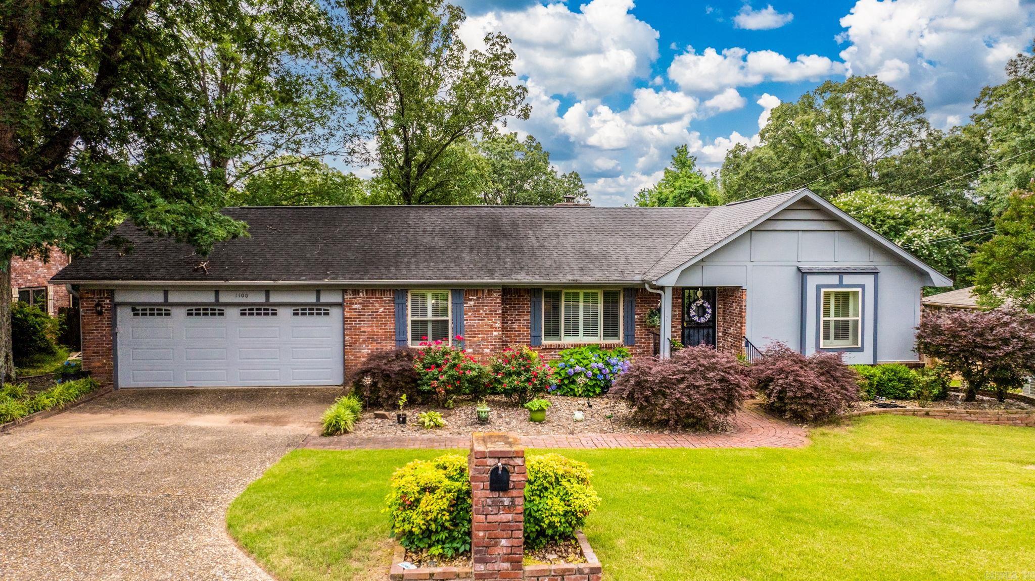 Lovely home features 4 spacious bedrooms (including 2 primary BRs) 2 bathrooms, a formal dining room, and an inviting eat-in kitchen. The home is designed for convenience, with all rooms on a single level. The kitchen features granite countertops, a stylish tile backsplash, an island, and ample cabinet space, plus a cozy area perfect for a coffee bar. The living room, complete with a fireplace, adds a touch of warmth and elegance. Built-in desk at the end of the hall is great workspace. All bedrooms have walk-in closets, plus an extra large storage closet in the hall. Beautiful plantation shutters and modern light fixtures enhance the home's appeal. Additionally, the home provides a workshop and plenty of storage space beneath, with easy access. The large, fenced backyard is ideal for outdoor entertaining, with a deck perfect for relaxing. A two-car garage and a level lot compliment the home's brick exterior. Agents see remarks for showings