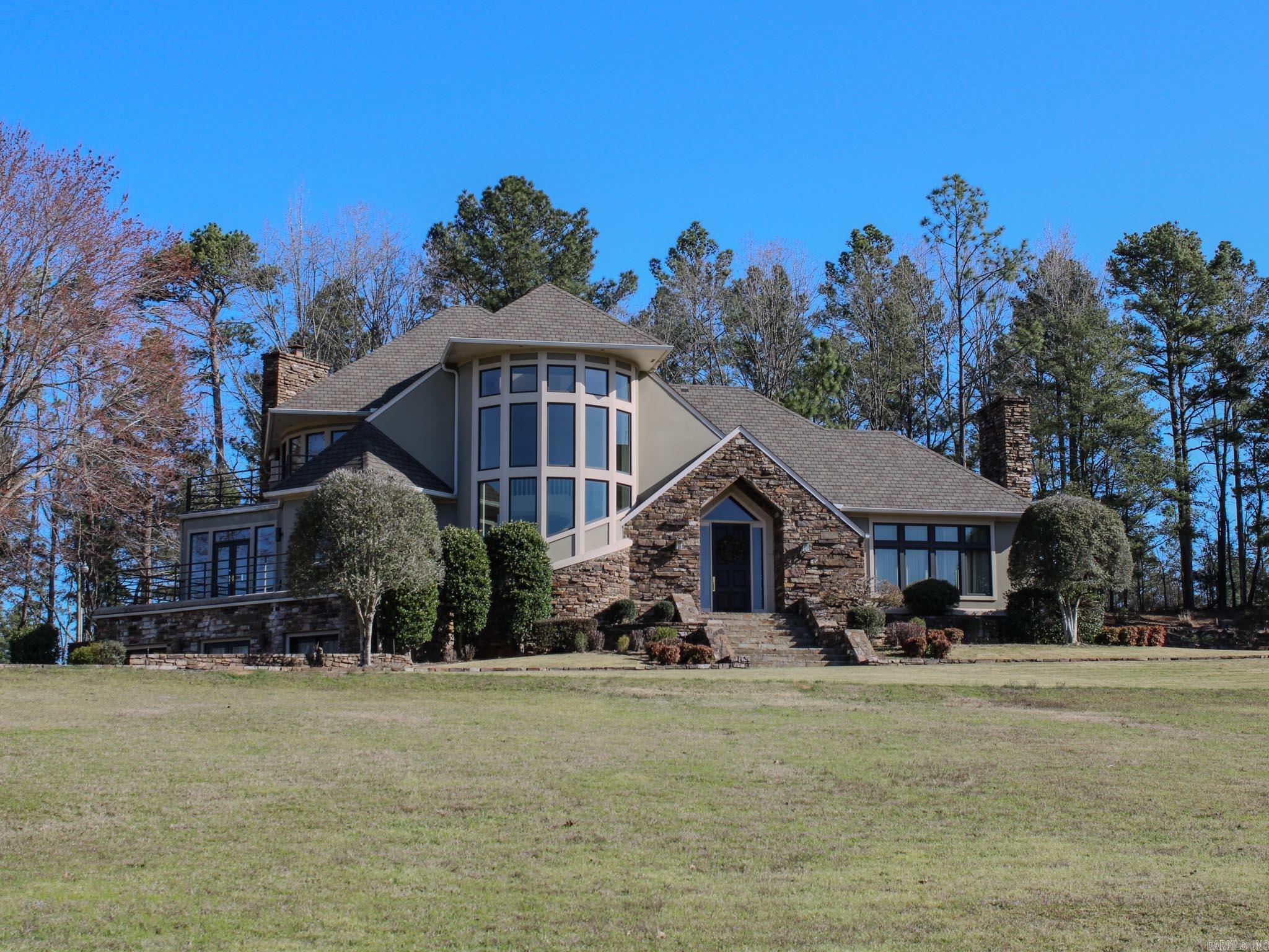 Stunning homes in a majestic setting! Two homes- over 9,000 square ft combined! 5.69 acres! 5812 HWY 5 has 4 bedrooms, 4 1/2 baths, 5,160 sq.ft & 5806 HWY 5 has 4-bedrooms, 3 baths, 4,278 sq.ft.. The grounds are iron fenced in front with a stone gate leading up to the Vista view homes! 5812 (larger home) features a classic stone entrance with 20' stone accent wall- 3 story spiral staircase- huge gameroom with full bath and kitchen- formal dining- 2 stone fireplaces- 2 large wrap-a-round balconies- new east & west decks- laminate and tile throughout! Family room, hearth room, breakfast room, sun room, laundry, unique pantries & office in both homes! Both homes have enormous windows for light throughout! 5806 also has 2 stone fireplacess, a grand staircase and a second back staircase, hickory hardwood flooring, large outdoor deck, oversized 3 car garage! Stone paving and massive rock waterfall highlight the swimming pool situated between the homes. Shared entrance splits into 2 driveways. Homes can be purchased separately! Pool negotiable with either home! Own these Landmark Benton Homes on Hwy 5! See agent remarks 5806 delayed occupancy
