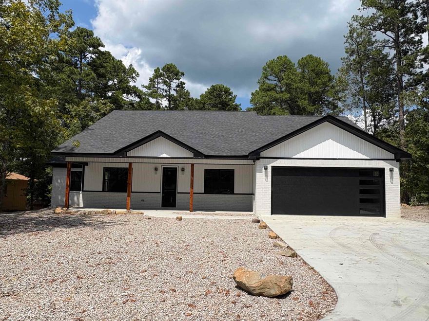 Stunning New Construction in Hot Springs Village!  Welcome to your dream home in the heart of Hot Springs Village—where modern design meets comfort, space, and resort-style living. This brand-new home offers crafted living space, perfectly suited for families, entertainers, and anyone seeking a blend of luxury and functionality.  The home features 4/5 bedrooms or could be used for alternative uses such as media/game/office, 3 full bathrooms across 2,610 sq ft of open living space. The modern kitchen boasts a large center island, sleek finishes, and a dream walk-in pantry—perfect for any home chef.  The primary suite is a true retreat with a spa-like ensuite bathroom designed for relaxation. Additional highlights include a two-car garage and a covered outdoor living area, ideal for morning coffee or evening unwinding.  Situated in the heart of Hot Springs Village, this home places you minutes from top-rated golf courses, resort-style pools, pickleball courts, walking trails, and the vibrant lifestyle that makes this gated community so desirable.  Don't miss this incredible opportunity to own a brand-new, move-in-ready home in one of Arkansas’s most beautiful and active communities.