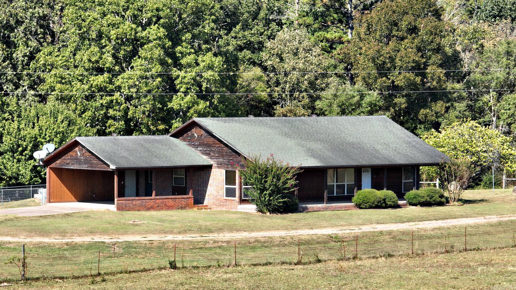 This is truly a one-of-a-kind property with everything you need to start ranching right away! Spanning 103 acres, this well-maintained ranch features lush pastures, an established hay field, abundant water sources for livestock, and even a private fishing hole teeming with fish. Nestled in a picturesque valley just west of Hatfield, the property offers stunning mountain views to the east, with beautiful sunrises and sunsets that are simply breathtaking. Perfectly located near the Mountain Fork River, which flows into Broken Bow Lake, this land is fully cross-fenced for efficient rotational grazing and easy livestock movement. Fully-equipped red iron truss horse barn complete with stalls, electricity, a bathroom with hot water, RV hookup, and tool storage. The property also features multiple entry points for versatile access, as well as a newer steel truss hay barn and equipment storage building. The ranch house itself is thoughtfully designed with low maintenance in mind.