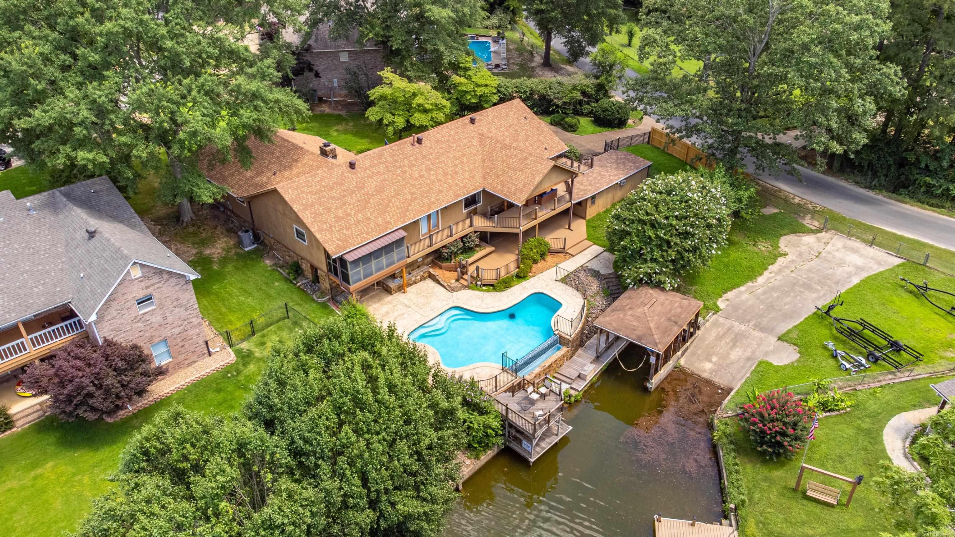 Welcome to Your Lakeside Retreat in the Lake Hamilton School District! Located in a charming, well-established neighborhood on the outskirts of town, this beautifully updated 4-bedroom, 3.5-bath traditional home offers 3100 square feet of comfortable living with stunning lake views. Step into the heart of the homeāa fully remodeled kitchen featuring sleek quartzite countertops, custom cabinetry, a spacious island, and top-of-the-line stainless steel appliances. Perfect for cooking and entertaining alike. Enjoy outdoor living at its finest with multiple composite decks and an infinity pool that overlooks a quiet cove on Lake Hamiltonāideal for peaceful mornings or evening gatherings. The walk-out basement is an entertainerās dream, complete with a large built-in bar and direct access to the outdoor spaces. Don't miss your chance to own this incredible home in the sought-after Lake Hamilton School District. A true gem with space, style, and lakefront serenity!