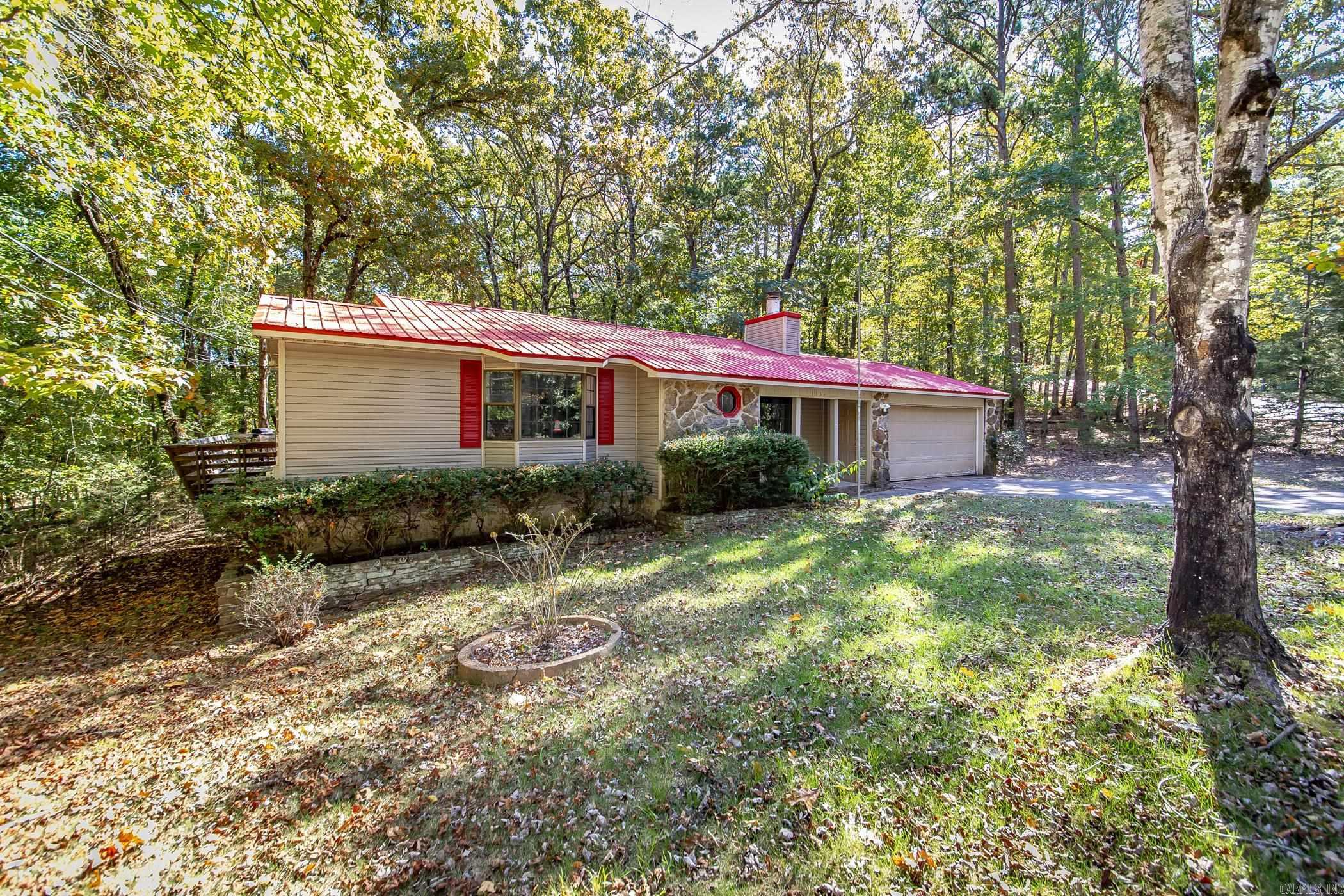 This home is rented and can't be shown until May. This charming home offers everything you need for a peaceful and serene lifestyle. Nestled just steps away from the stunning Greers Ferry Lake, you can enjoy leisurely strolls to the water's edge right from your backyard. For those warm sunny days, a quick walk will take you to the inviting Hamilton Cove pool, perfect for a refreshing dip or a relaxing afternoon. The home boasts a spacious, freshly painted interior that's ready for you to make your own. With a large garage, you'll have plenty of space for storage or hobbies. The durable metal roof adds to the home's low-maintenance appeal. Step outside to a large deck that provides the perfect space to unwind while overlooking the natural beauty that surrounds you. Whether you're sipping your morning coffee or hosting a gathering, the tranquil setting is sure to impress. As the sun sets, gather around the cozy firepit area for an evening under the stars with family and friends. OWNER FINANCING: 20K down, 175K over 20 years @8.75%. Monthly payments 1518.69. Don't miss out on this rare opportunity to own a slice of paradise in Fairfield Bay.