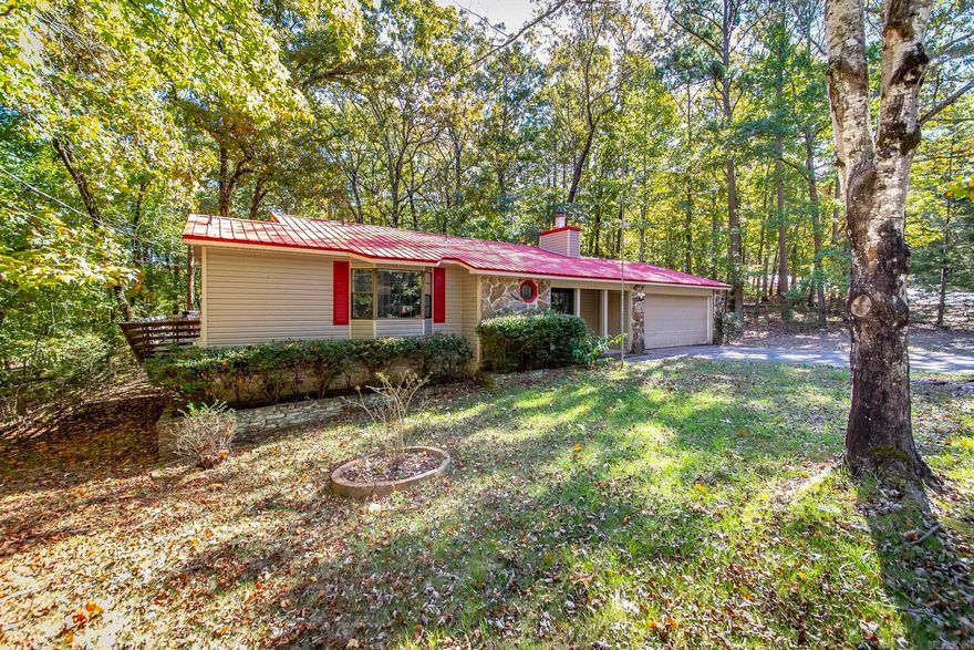 This home is rented and can't be shown until May.  This charming home offers everything you need for a peaceful and serene lifestyle.  Nestled just steps away from the stunning Greers Ferry Lake, you can enjoy leisurely strolls to the water's edge right from your backyard. For those warm sunny days, a quick walk will take you to the inviting Hamilton Cove pool, perfect for a refreshing dip or a relaxing afternoon. The home boasts a spacious, freshly painted interior that's ready for you to make your own. With a large garage, you'll have plenty of space for storage or hobbies. The durable metal roof adds to the home's low-maintenance appeal. Step outside to a large deck that provides the perfect space to unwind while overlooking the natural beauty that surrounds you. Whether you're sipping your morning coffee or hosting a gathering, the tranquil setting is sure to impress. As the sun sets, gather around the cozy firepit area for an evening under the stars with family and friends. OWNER FINANCING: 20K down, 175K over 20 years @8.75%.  Monthly payments 1518.69.  Don't miss out on this rare opportunity to own a slice of paradise in Fairfield Bay.