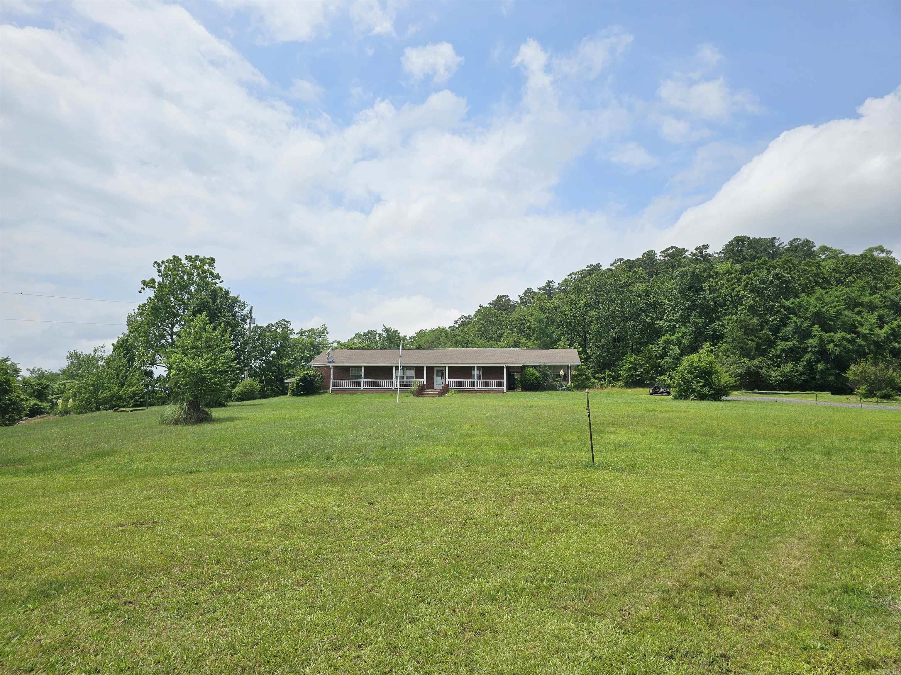 Very nice home located in the heart of Mena on a hill with a mountain view. Sit outside in the gazebo listening to the babbling music of Ward Creek. This large 4 bedroom 2 bath home is located in Mena, AR on 1.12 (+-) acres, features are: large in ground storm shelter, 2 car carport, raised garden bed, shop/storage building, 4 very room bedrooms, laundry room, open kitchen dining and living room area, remodeled hall bath and so much more. Agents see remarks.