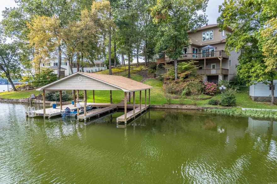 Lake Hamilton Waterfront Living at Its Finest — Welcome to 117 Gregory Drive. Wake up to peaceful water views, step onto your private dock, and spend the day boating, or simply relaxing along the shoreline. Located directly on Lake Hamilton, 117 Gregory Drive offers the rare opportunity to experience the best of lake living in Hot Springs. Designed for everyday comfort and memorable gatherings & featuring five+ bedrooms and three bathrooms ,this home creates room for family, guests, and weekend entertaining. Large windows and open living areas brings lake views into the heart of the home, while multiple indoor and outdoor spaces make it easy to enjoy the scenery year-round. Just minutes from the restaurants, golf courses, and entertainment of Hot Springs, this property offers convenient access for weekend escapes from nearby cities such as Dallas and Little Rock, making it an excellent option for a primary residence, vacation retreat, or investment opportunity.  Homes with this combination of waterfront access, generous space, and prime lake location are increasingly rare. This is more than a home. It is lake living the way it was meant to be experienced.