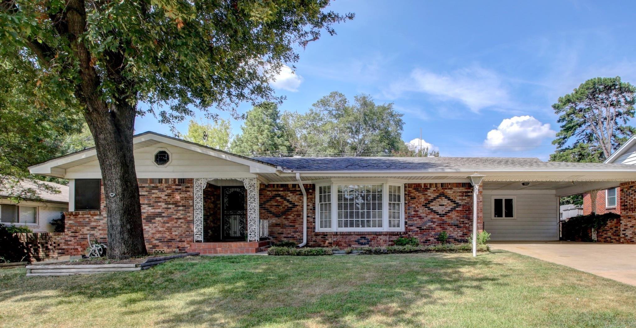 You'll fall in love with this mid century classic! So much character with many original features still in place including the beautiful stacked stone fireplace, stacked stone wall, and oversized tile patio! All brick, one level, and convenient midtown location. The versatile floor plan offers you 2 living areas and a dedicated dining space. The eat in kitchen features a gas cooktop, double wall ovens and there is even a dedicated laundry room just off the kitchen. The backyard is fully fenced in and includes 2 outdoor storage areas for yard equipment, bikes, toys and more! Schedule your showing today!