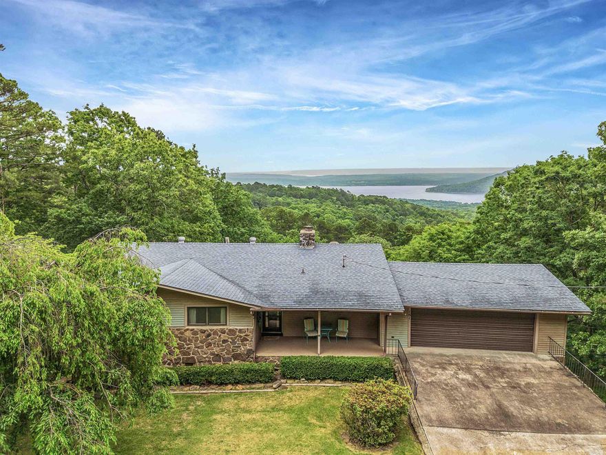BREATH-TAKING VIEW OF SUGARLOAF MOUNTAIN ON GREERS FERRY LAKE!! This view can be enjoyed from across the back of the house (living room, dining room and kitchen, BR) & the expansive deck.  The large living room has a fireplace, plenty of space for furniture arrangements, & the view!  The galley kitchen has lots of prep space, nice appliances, & direct access to dinette area.  A nice pantry, access to oversized garage/shop, & nice laundry room.  The Master BR has a 3/4 bath.  The guest bath has tiled walls & tub/shower surround that are vintage, but in excellent shape & clean!  One Guest BR is large, & BR3 is smaller, but can be a great office too.  The deck with a view draws you outdoors to relax with a cup of coffee or "After 5" drinks, to read & watch birds,or enjoy cookouts.  Some recent updates:  Roof, HVAC, new refrigerator/freezer, water heater, faucets, some outlets, new guttering.  The garage has extra space for a workbench, plus LOTS of storage.  From the garage you can access the lower basement for storage, & possible safe room.  This has been used as a short-term rental, so everything is nicely decorated, maintained for Guests to enjoy.  Some furniture is negotiable. AR