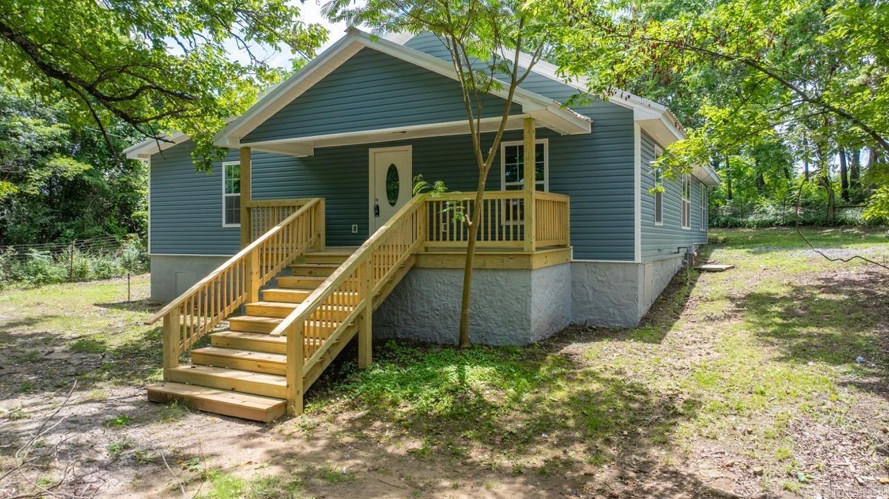Welcome to 915 Bethesda Rd. in Batesville, AR—where quality, comfort, and opportunity come together. This 3 bed, 2 bath home has been fully remodeled from the studs up and offers nearly 1,976 sq ft of thoughtfully designed living space. Enjoy a bright open floor plan, large kitchen with a custom breakfast bar, beautiful wood cabinetry, epoxy countertops, and all-new fixtures, trims, and paint. The bedrooms are spacious, and both bathrooms are oversized and modern. Sitting on approx. 4.75 cleared more or less acres with a private driveway, storm shelter, and TWO access points, the land is ready for your next move—with septic, city water, and electric already in place for a second home, mobile, or shop. Just minutes from town, yet perfectly private—this property is full of potential!