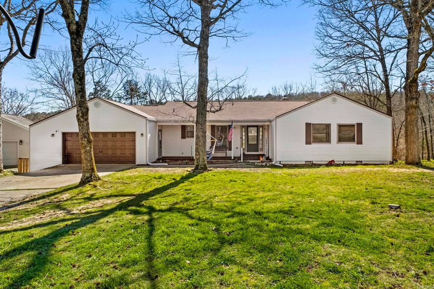 Your lake home awaits! This well-maintained home is situated on two lots, offering additional space and flexibility for future improvements such as a shop or outdoor living area.  The home features an open-concept layout with a breakfast bar, wet bar, ample cabinetry, and updated appliances—ideal for both everyday living and entertaining. The cozy living room includes a wood-burning fireplace and large picture windows that showcase beautiful mountain views.  Recent updates include new LVP flooring and a spacious sunroom/flex space that can be used for a variety of needs. The garage is currently being utilized as storage and an additional bedroom with a closet and HVAC but can be converted back to a traditional garage if desired. A protective mat will convey for optional vehicle use.  Additional features include a whole-house generator, a super clean crawl space and storage area, and a peaceful setting to enjoy the outdoors from the back deck.  Conveniently located across from Indian Hills Golf Course and just minutes from all the amenities Fairfield Bay has to offer.  Water softener system does not convey. *Agents see Remarks*