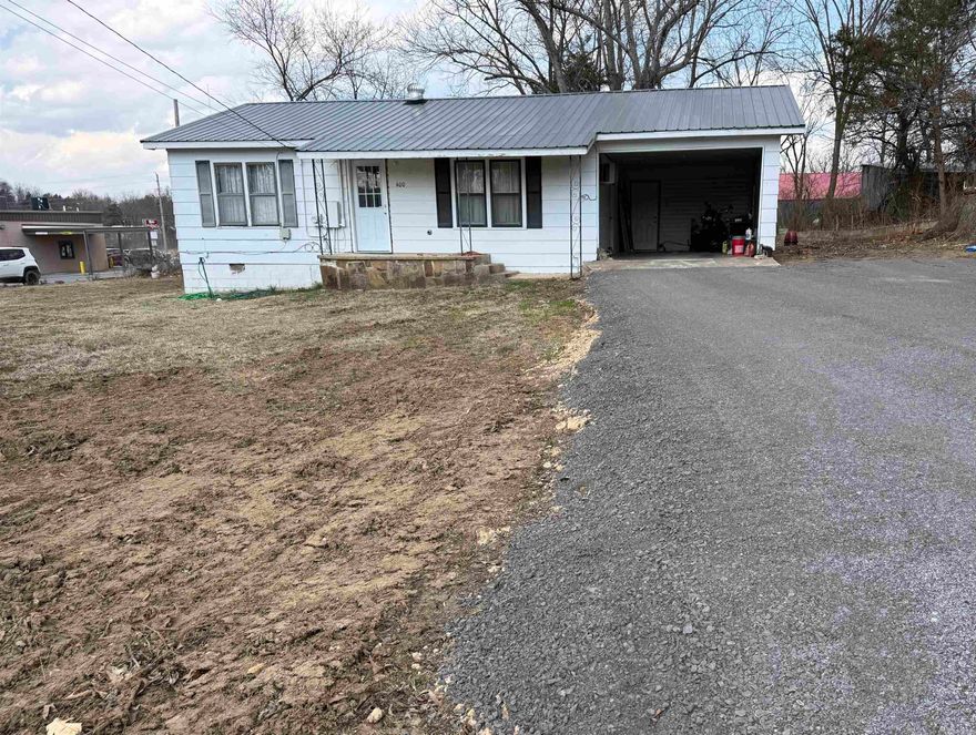 Conveniently located right on Main Street, this 900 sq ft home offers simplicity, affordability, and a cozy atmosphere. While modest in size and finish, the home has a warm, inviting feel with wood-paneled walls throughout much of the interior.  The layout includes comfortable living space, a functional kitchen with ample cabinetry, and a full bath with updated shower surround. The bedrooms are practical and comfortable, making this property ideal as a starter home, rental investment, or downsizing opportunity.  A large attached carport provides excellent covered parking and additional space for storage or hobbies. At the rear of the carport, you’ll find a laundry and storage area, adding valuable utility space not reflected in the main square footage.  With its prime Main Street location offering quick access to town amenities, this property presents a solid opportunity for buyers seeking convenience and value.