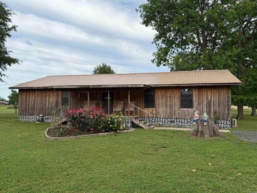 Situated on 3.6 acres, this unique property offers space, flexibility, and endless possibilities. Originally a 16x60 single-wide mobile home, it has been expanded into a spacious home featuring 4 bedrooms, 3.5 bathrooms, and approximately 2,112 heated square feet. The home also includes a separate dining room, large walk-in closet, and a walk-in safe room built within the home. Additional features include a gas ventless log fireplace, gas emergency heat unit, 25x24 carport, 22x12 screened-in porch, and a wood storage building. A standout feature of the property is the 40x50 metal shop with a 20x50 enclosed area and a 20x50 overhang. The enclosed portion is finished with beautiful cypress lumber on the interior and offers potential for additional living space, guest quarters, or even a separate home. The rustic finish can be enjoyed as is or customized with stain to match your personal style.
