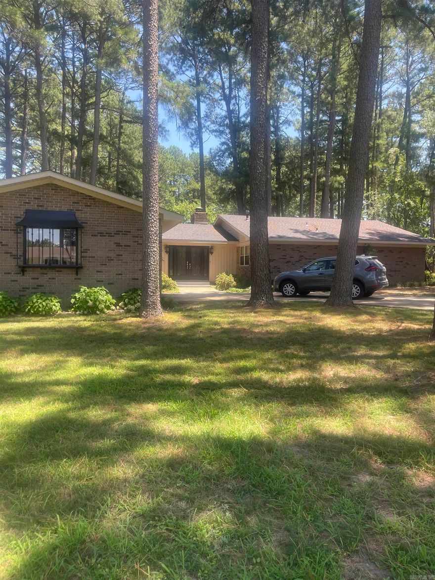 Beautiful all brick home sitting on a corner with 1.58 acres (+/-). Three bedrooms and two bathrooms.  Updated kitchen. Living room and den share a gas log double sided fireplace. Large Dining room off of the kitchen that is perfect for entertaining.  Laminate flooring throughout with the exception of tiled kitchen and bathrooms.  Covered, screened in back patio.  Two car garage and large utility building.  New roof and new hot water heater in 2023.