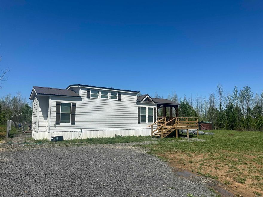 Perfect set up to enjoy in this tiny house while building your dream home on 10 acres!  Most of acreage is cleared for a future building site.  Home is 'So Cute' and has wood features throughout!!  One bedroom or storage area on main level plus a pantry room, kitchen, bath and living room area. Washer, dryer and refrigerator built in. Upper level has big master bedroom and TV area.  Nice covered deck area to enjoy mother nature!  Home does not have permanent foundation and can be moved.  8x12 Storage building stays.  Property has fencing around entire property (horse wire around back of land and regular fencing on front with gate), underground power to home and septic system on north side of home. Grand Prairie water. Survey & disclosure on docs on line.