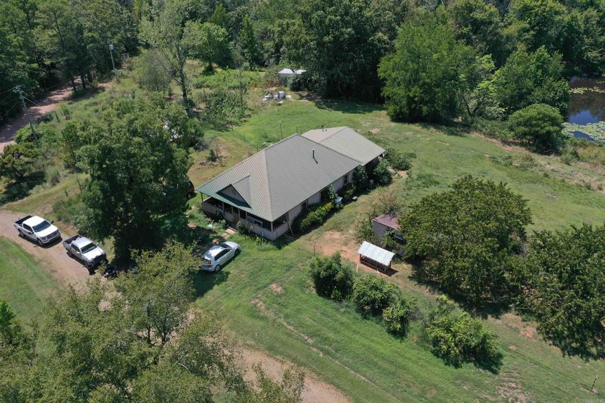 Located off of Brush Creek Road in Harvey, Arkansas sits this country home and two +/- acres. Along with the 1728 square foot home, the property has a small workshop and storage building, as well as an additional septic, water, and power hookup that could be used for a camper hookup. The home boasts 4 bedrooms and two full baths, along with a living room, large dining room, and kitchen with custom cabinets. A newer metal roof has been added to the home along with newer siding, giving it a fresh look and alleviating future concerns. The covered front porch faces the east for the perfect place to enjoy a morning cup of coffee. The home has been recently updated in every room, has new appliances, and is ready for its new owner. Along with the well that is located on the property, the home is currently connected to Tri County water service, and has Fiberoptic internet and landline phone provided by Arkwest. The Ouachita National Forest is just a short half mile drive down the gravel road, and the Fourche La Fave river is just minutes away as well. Whether you are looking for a forever home, a weekend getaway, or a hunting cabin, this property checks a lot of boxes.