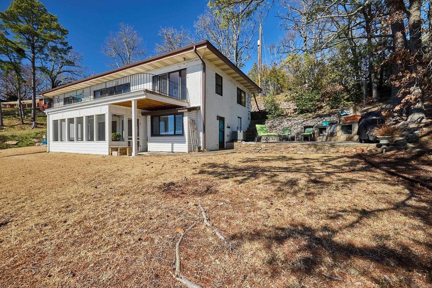 This Lake Hamilton Home has a magnificent view with year round water and over 101 feet of lake frontage. Inside you will love the light and bright atmosphere with two living areas complete with fireplaces! Outside you will admire the deck, screened in porch and flagstone patio to relax! Get ready for amazing sunrises and sunsets with the stellar views from every room!
