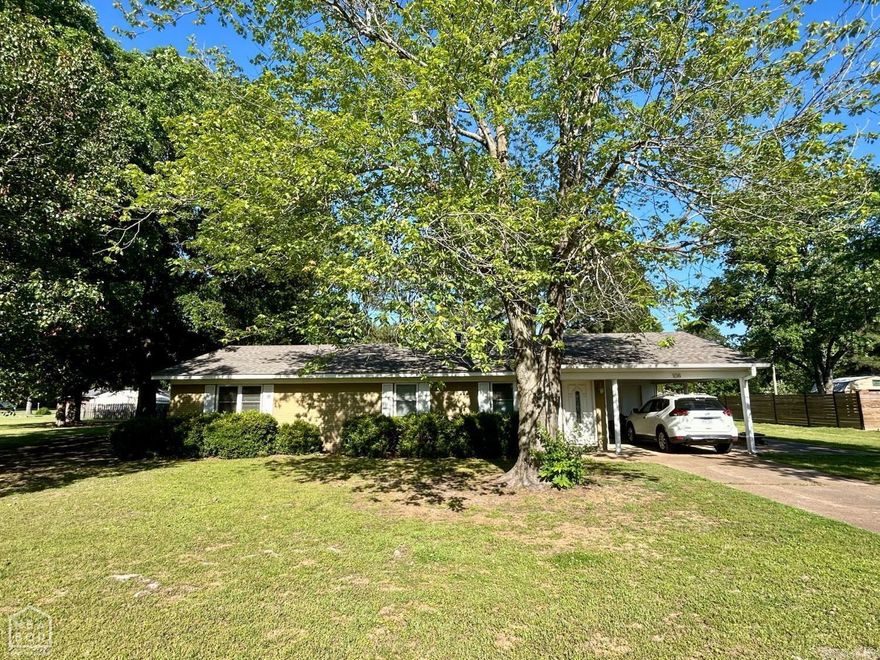 Charming 3 bedroom, 1.5 bath home with wonderful features throughout! The kitchen showcases custom cabinetry with beautiful granite countertops, perfect for everyday living and entertaining! The kitchen also includes stainless appliances that will convey with the sell of the home! There is tile flooring throughout the home (with additional flooring materials to complete a small area). Step out back to enjoy the spacious backyard with a wood privacy fence! As if this home and yard wasn't spacious enough, there is an additional lot with mature shades that has endless possibilities: divide and sell, or create your dream space with a shop, man cave, or mother-in-law suite. This home is a must see!