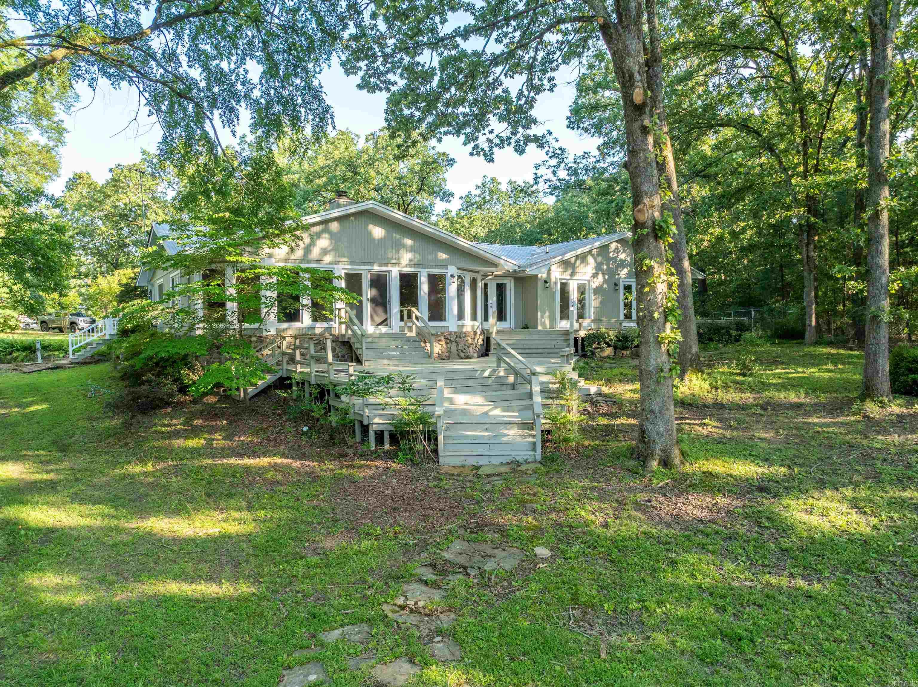 LAKE HAMILTON WATERFRONT ESTATE -NO REASONABLE OFFER REFUSED...WAS $897,000-NOW ASKING $797,000... 512 Beach View Dr. Exceptional five bedroom three bath one level home (3,156 SF) on a beautifully landscaped 9/10 of an acre (level lot) w/ approximately 100 feet waterfront. PLUS a 40āx30ā Greenhouse that would easily convert to a guest cottage or a workshop. This property is approximately one block from the Lake Hamilton Fish Hatchery boat ramp -you can easily have your boat in the water in less than 10 minutes! This property would make a great nightly rental investment (it is located in the county and no short term rental license is required). The owners have relocated out of Hot Springs and are very anxious to sell! Buyers agents please see the agent remarks.