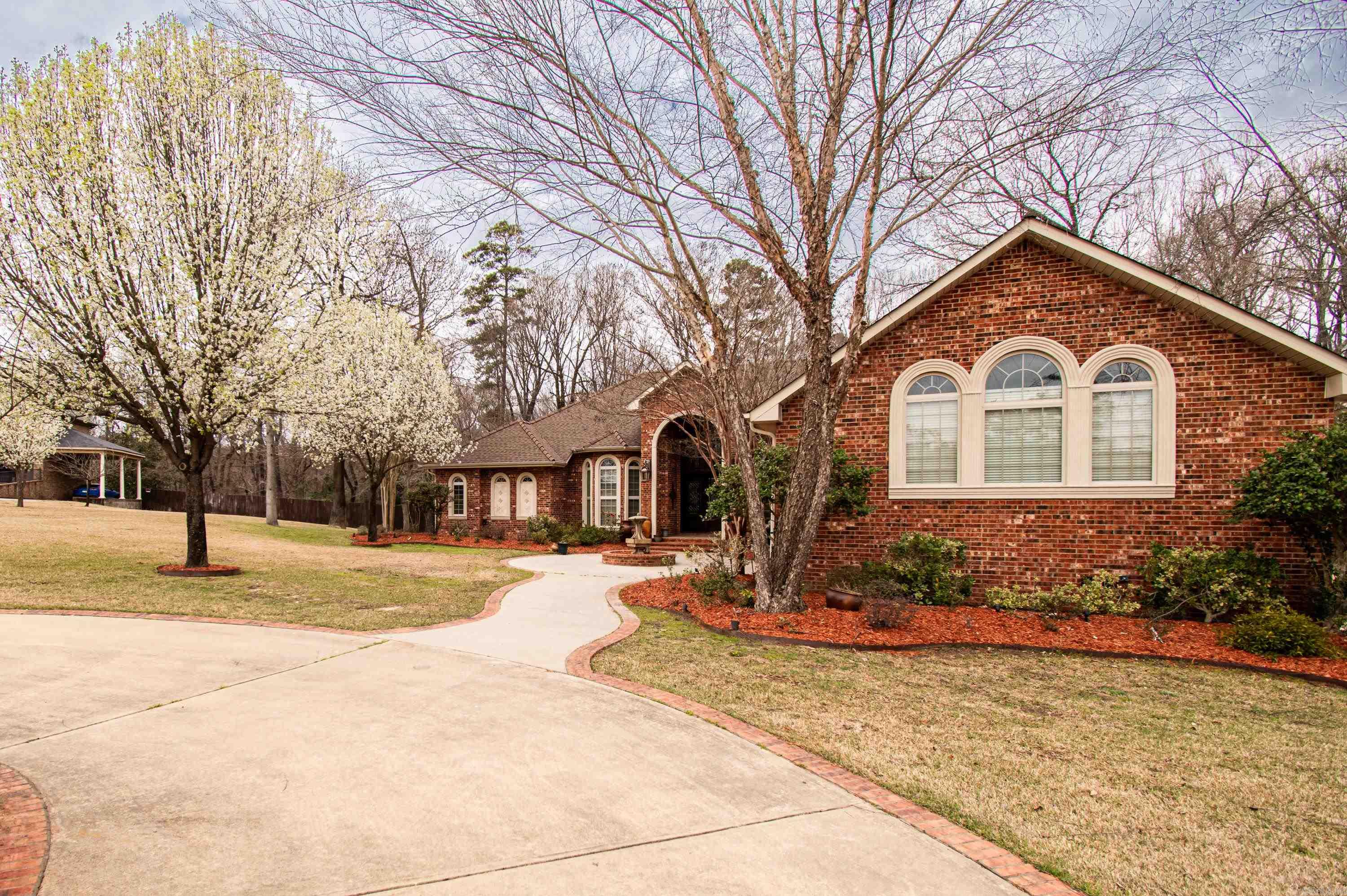 This custom built home located in Timber Hills Subdivision boasts a Beautiful Hand-Crafted front door made from Spanish Cedar. Cut glass highlights the upper & lower sections of the 17' high entryway with the rest of the home featuring 10' & 12' ceilings with hand-crafted arches and columns. The columns were painted by a local artist, Darrin Riley and match the granite counter tops. Entry elongated with gas lamps and fountains within the circle drive. Kitchen cabinets were built on site utilizing solid maple crown molding with maple doors and additional trim fabricated from maple stock. Area behind gas stove is highlighted with Italian tile artwork made specifically for current owner. 8' doors and triple stack crown molding throughout home for Elegance! Master Bath features a custom walk-in shower with rain head and body sprays. There is a 26" deep tub highlighted by a fireplace with custom mantle topped by a Frank Thompson custom oval window with cut glass. Sprinkler System front & back with 9 zones and 2 continuous water heaters