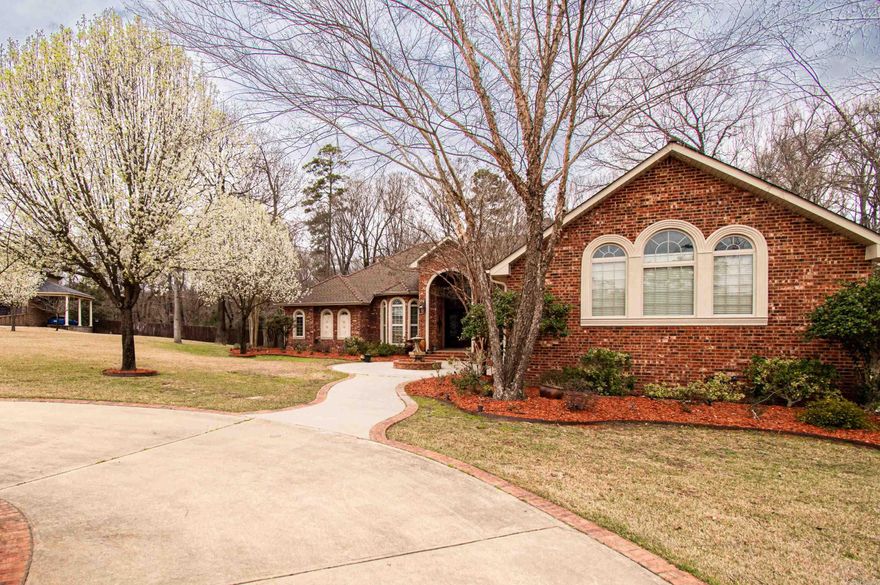 This custom built home located in Timber Hills Subdivision boasts a Beautiful Hand-Crafted front door made from Spanish Cedar.  Cut glass highlights the upper & lower sections of the 17' high entryway with the rest of the home featuring 10' & 12' ceilings with hand-crafted arches and columns.  The columns were painted by a local artist, Darrin Riley and match the granite counter tops.    Entry elongated with gas lamps and fountains within the circle drive.   Kitchen cabinets were built on site utilizing solid maple crown molding with maple doors and additional trim fabricated from maple stock.  Area behind gas stove is highlighted with Italian tile artwork made specifically for current owner.  8' doors and triple stack crown molding throughout home for Elegance!  Master Bath features a custom walk-in shower with rain head and body sprays.  There is a 26" deep tub highlighted by a fireplace with custom mantle topped by a Frank Thompson custom oval window with cut glass.  Sprinkler System front & back with 9 zones and 2 continuous water heaters