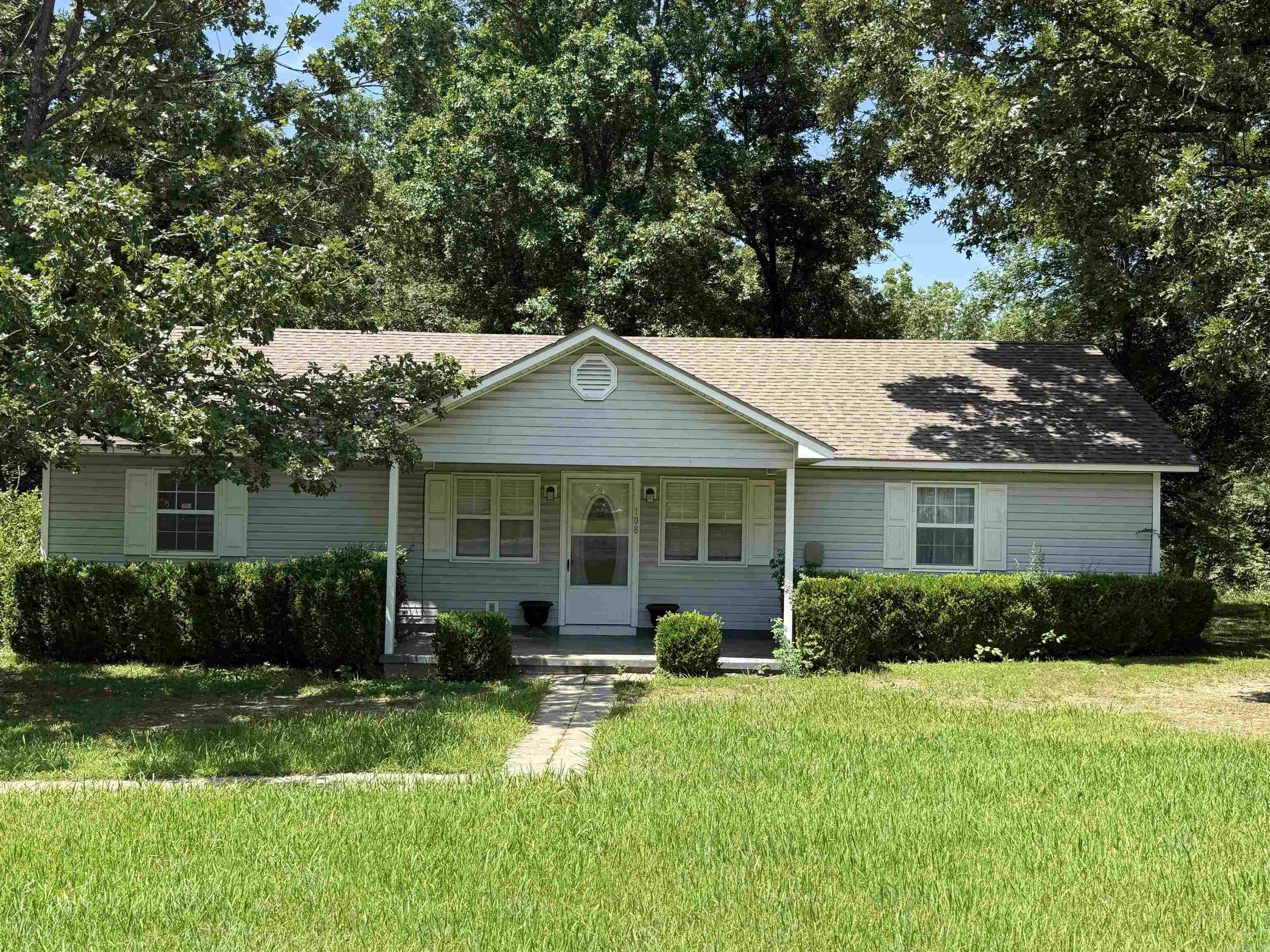Welcome to 108 Rock Street, a cozy and well-kept 3-bedroom, 2-bath home offering approximately 1,300 square feet of living space on a generous .98 +/- acre lot. Tucked away at the end of a quiet dead-end street, this property offers peaceful living with minimal traffic—perfect for those seeking privacy and a slower pace. The home features an open floor plan with a large comfortable living area, a spacious kitchen, and kitchen appliances that convey! Step outside on the back deck with mature shade trees to enjoy a large yard with outbuildings included, providing ample storage or workshop potential. Located in Marshall Arkansas, near the grocery store, civic center, city pool, park, school, churches, and the year-round drive-in movie theater, this home is ideal for families, retirees, or anyone looking for small-town charm with added space and convenience.