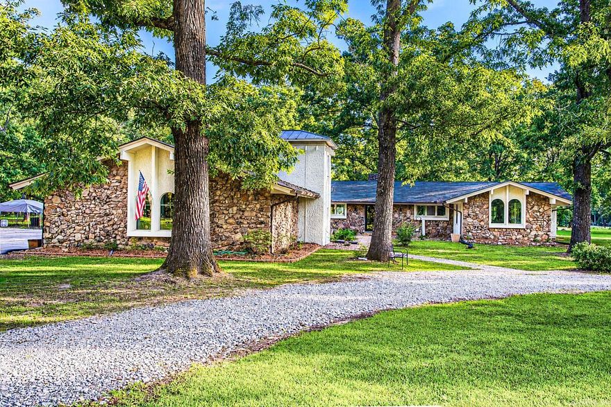 This Single Story Charm filled home has 3 Bedrooms, 2.5 Bathrooms and a 3 car garage. It includes many modern updates along with a complete restoration in 2022. Property includes a newly built 2200 square foot , 38X60 Hobby Shop, adjacent to the shop is an RV Pad with electricity. Both Structures are nestled on a flat and private 7.7 + - acres that abound with mature red and white oak trees. This shaded property is ideal for outdoor activities and an outdoor lifestyle. Features include extra large patio, picturesque window views throughout the home, two fireplaces along with a circular drive and a dog run. The spacious primary suite includes a large custom walk in shower and closets along with an adjoined office/sitting room also with a view. Property is 30 minutes from Little Rock , 30 minutes from Sheridan and 2.5 miles from beautiful Tar Camp Park on the Arkansas River.  Other improvements include kitchen remodeled with real quartz counter tops, updated custom showers, newer hot water tanks along with newer HVAC systems.