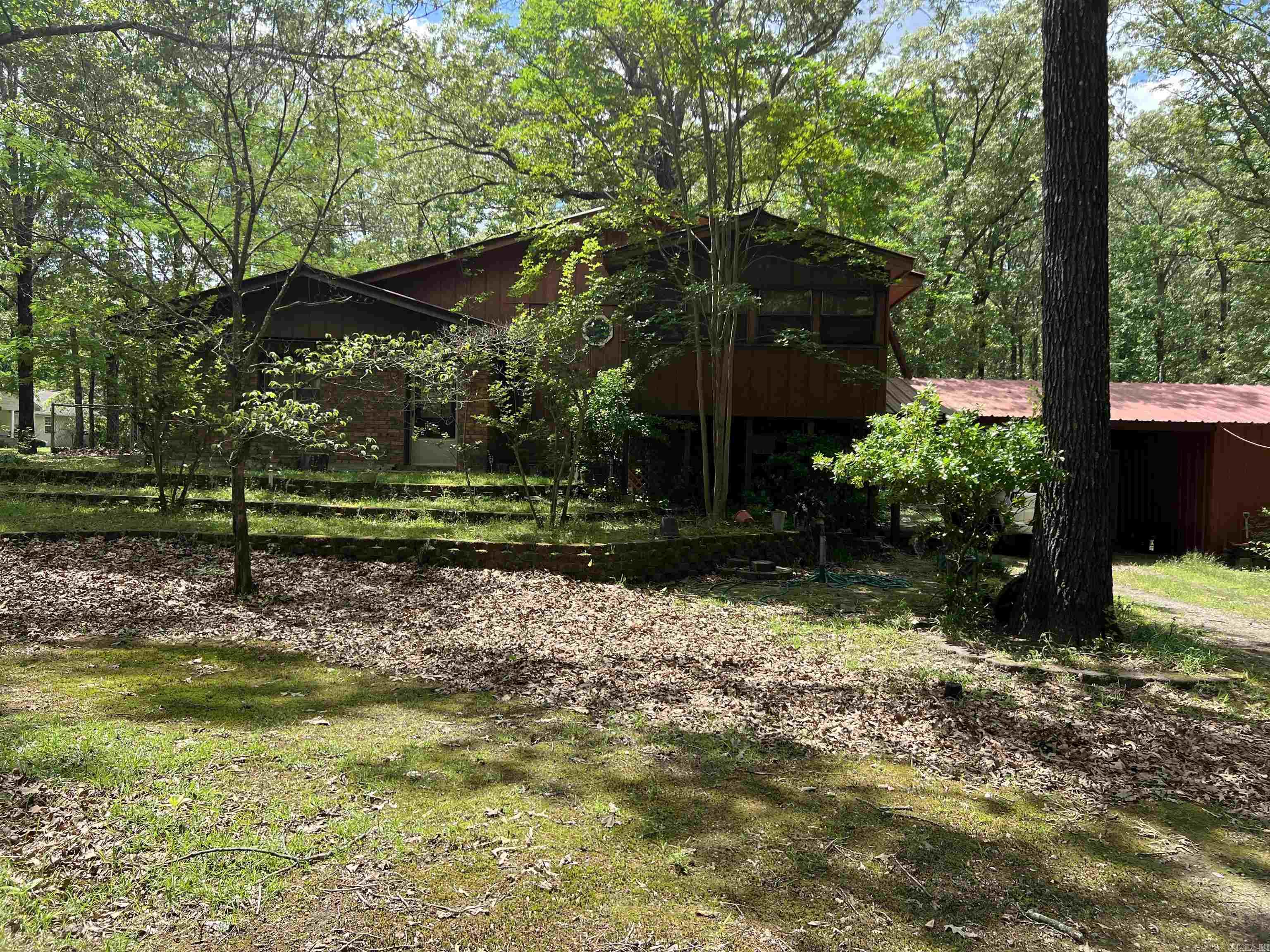 Don't miss this unique as-is investment opportunity! This spacious 2-bedroom, 2-bath tri-level home offers incredible potential for the right buyer. Nestled on just over three acres, this property provides ample space, privacy, and room to grow. The home features a functional layout with a living room and sunroom on the main level, perfect for entertaining or relaxing with a view of the surrounding land. Upstairs, you'll find a versatile bedroom currently being used as a workout room. The bottom level includes a second bedroom, a full bathroom, kitchen, and laundry room/ Additional highlights include a carport with attached storageāideal for tools, outdoor equipment, or hobby gear. With a bit of TLC, this home could be transformed into a great primary residence, rental property, or weekend retreat. Plenty of potential and land to work with this is an excellent opportunity for investors or handy homeowners!
