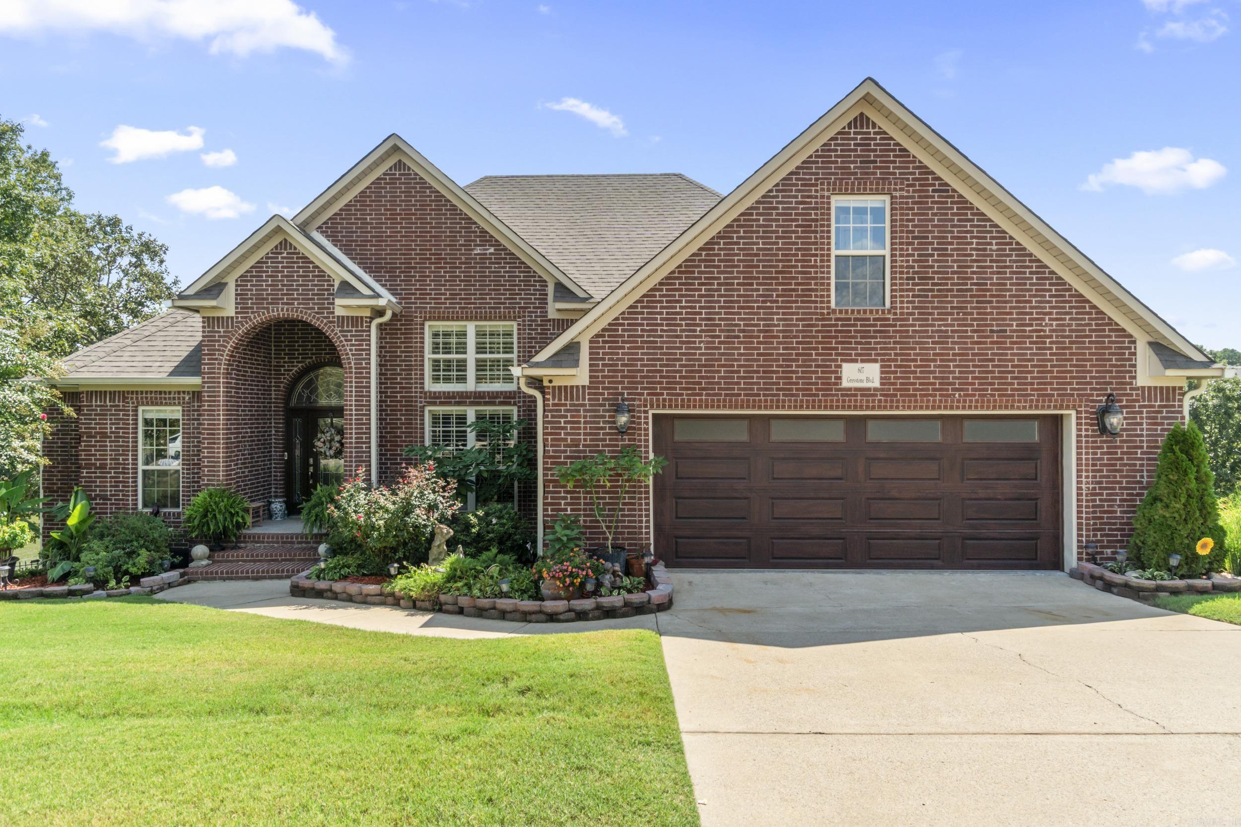 This immaculate home with amazing views of the water has 4 bedrooms, 3 baths and a bonus/theatre room. Additional Features include: Open foyer leading to a living room with high ceilings, custom crown molding, plantation shutters and a gas-log fireplace with switch start; formal dining; kitchen with all new SS Frigidaire Pro & Gallery appliances, granite counters, backsplash, pull out cabinet shelves and breakfast nook. Central vacuum, new carpet upstairs, Quartz counter tops in bathrooms, extra decking in attic for storage, tray ceilings, walk-in shower, breakfast bar and insulated doors/windows. Covered double patio overlooking the lake, with a private dock for private lake access, fishing or paddleboating. Lower deck is wired with 220 amp for installation of a hot tub or spa. New Safe Step Walk-in Tub was added 3 months ago with all the features...lights, sound, bubbles and massage. Tons of stone, shale, top soil and sod have been added to raise the backyard up 3 feet and sprinkler system installed. See docs for additional information. Call today to schedule your showing on this property!!