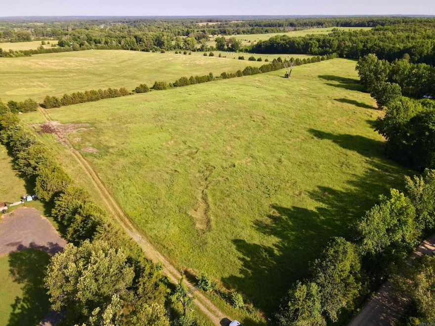This property is a hay producer's dream with 120 acres of meticulously maintained hay ground, soil-tested bi-yearly, and fertilized up to three times a year which produces about 1500 bales annually. The farm is fully fenced and cross-fenced, ensuring optimal land management. A spacious hay barn, secure storage container, and a deep well enhance the farm's functionality. Located in a very desirable location you may want to build your family home or convert the property into a beautiful highly productive horse or cattle operation. This exceptional 127-acre farm also features two stocked catfish ponds and a bass pond. Don't miss this unique opportunity to own a well-equipped and productive farm.