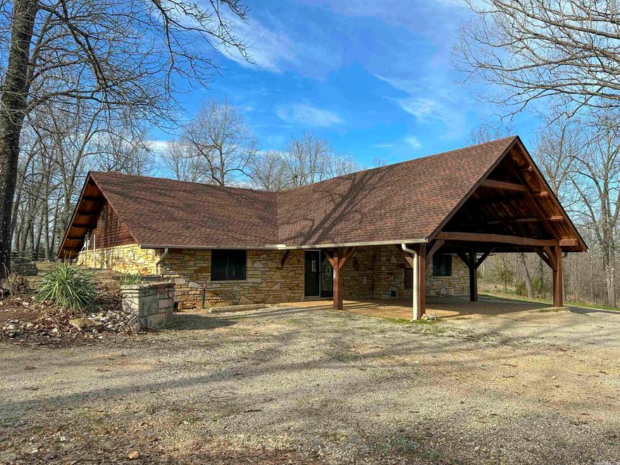 HIGHLAND...MASSIVE HARDWOOD TIMBER FRAME FEATURES...Enough frontage on Hwy 62/412 for commercial access & private enough to think you are down a dusty county road. Several upgrades have been made. So distinctive you will know that it took many back breaking hours to create this artistic 2-4 bedroom home, barn & shop on 8 acres, with a master plan of artistry. From the garden to the mortise & tenon craftsmanship of massive beams, you will know that the stone mason who created this dream was an artist of extreme vision, skill and historic knowledge. The warmth of the Russian furnace (also piped to radiate floor heat), aesthetics of traditional fireplaces, security of an indoor cellar, barn for livestock and a shop of concrete from top to bottom, would cost a small fortune to create with today's costs. Do not let this amazing opportunity of the Ozarks slip past you.  It should be a bidding war by everyone who understands what is truly being offered for sale.