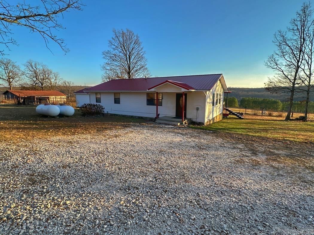 This picturesque 92 acres m/l includes a mix of pasture, forest, and views which accentuate this pretty farm in the heart of the Ozark Mountains. 3BR 2BA ranch home features a split floor plan, sunroom, & covered deck. Detached man cave/she shed, 2 barns, newer 30x40 garage/shop. Bring your animals to populate the pasture while the natural wildlife (deer, turkey, bear, etc.) roam the forest. Pasture includes fencing & ponds. Forest features include large rock formations, cave, and seasonal creek/waterfall. Lots of possibilities for the farmer/hunter/naturalist. This property has something for everyone, and when you rarely want to get a change of scenery, you're less than an hour to Harrison/Huntsville/Eureka Springs and slightly over to Fayetteville/Springdale/Rogers/Branson, MO, Beaver, Table Rock, Taneycomo and Bull Shoals Lakes and the White, Buffalo, and Kings Rivers. In the center of many hunting, fishing, canoeing, swimming, camping, hiking and sightseeing venues! Come experience the Ozarks better from here!