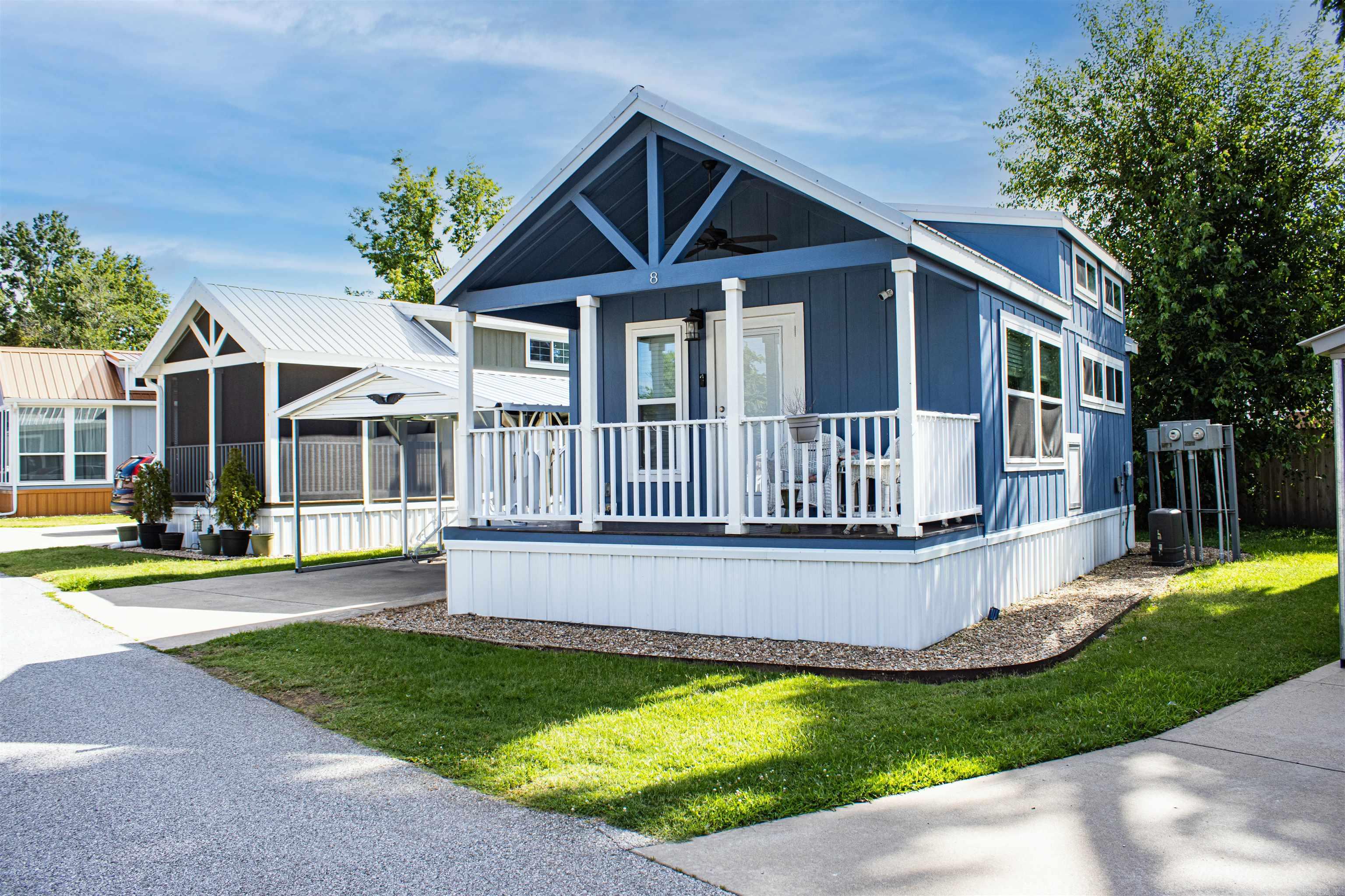 Welcome home to this Adorable 1 bed, 1 bath Tiny Home with a bonus loft area in a peaceful 55+ community in Rogers. Built in 2018, this all-electric home offers low-cost, low-maintenance living with thoughtful upgrades throughout. Enjoy the inviting front porch and private back deck. Inside features LVP flooring, window blinds, ceiling fans, double-insulated walls, and two mini-splits for year-round comfort. The kitchen includes a center island and full-size stainless steel appliances. The bedroom offers two closets with a built-in dresser for generous storage. All appliances convey, including washer, dryer, and refrigerator. Additional features include metal roofing, security system, and a detached 350 sq ft storage building. Located across from the dog park with access to a community storm shelter. Must be owner-occupied and 55+. Rentals not permitted. Close to Downtown Rogers, shopping, dining, parks, schools, greenway, hospital, and fire station.