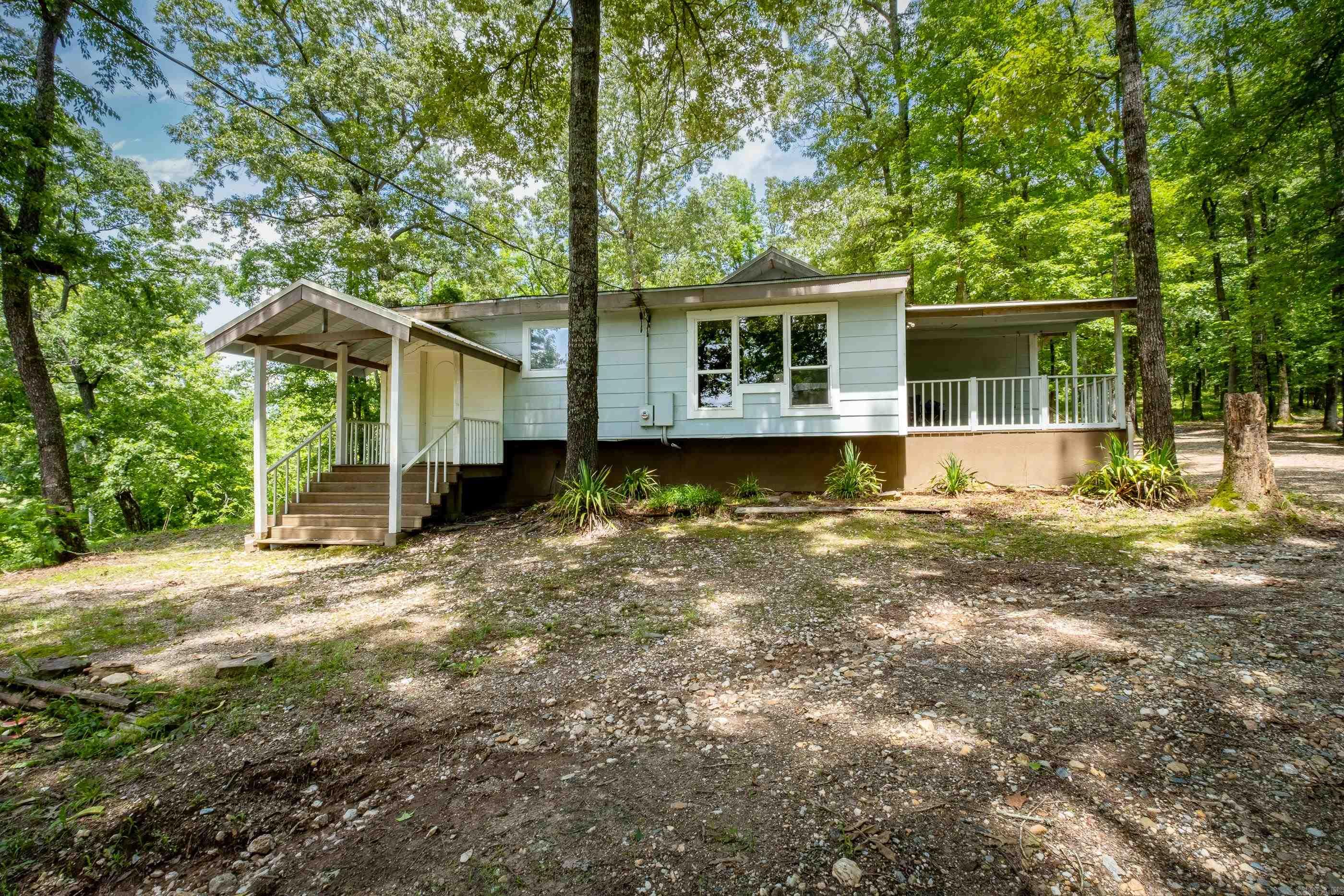 Come see this one-of-a-kind property, A national park-like setting near Little Rock Hot springs and Benton. With pristine "old-growth" trees overlooking a clear year-round creek that has swimming holes for the kids on hot summer days. This unique property has miles of trails featuring suspension bridges and footbridges that take you through old-growth pristine woodland. The creek water filters through natural occurring quartz crystal gravel that has a bluish clearness and is a great soak and swim experience. The custom 3 bed, 2 bath house is a serene escape which blends seamlessly with nature. This home's three comfortable bedrooms are perfect for restful nights surrounded by the quiet sounds of the forest and creek. This woodland retreat surrounded by pristine nature is a true sanctuary for birds, wildlife and you. It helps you forget life's ups and downs and let's you just soak up the beauty and tranquility of this part of the Natural State. See Agent Remarks