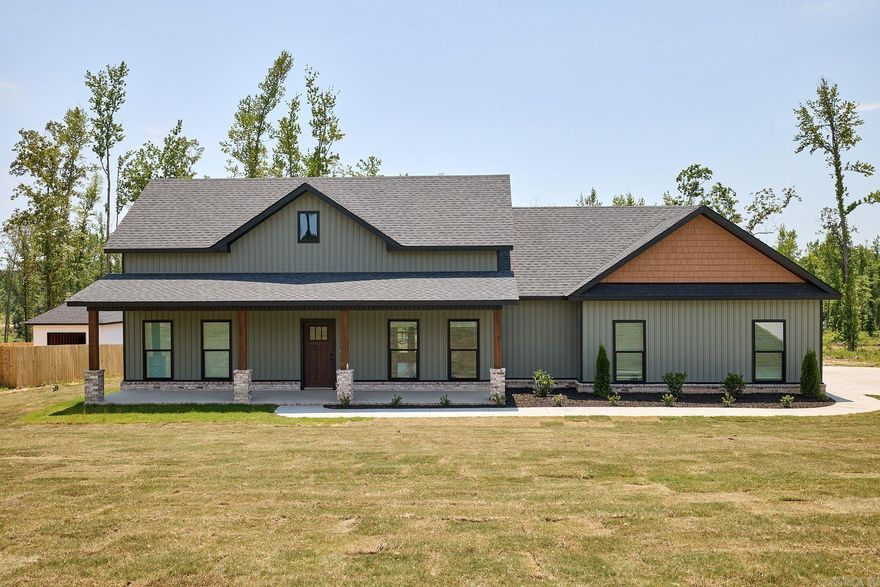 Welcome home to this beautiful 3 bed, 2 bath property situated on 1 acre in Bauxite! This inviting home features custom beamed wood ceilings, quartz countertops, a spacious dinning room, large foyer, walk-in pantry, 2 car side entry garage, and a cozy wood burning fireplace perfect for relaxing evenings. The primary suite offers a standing tub and walk-in shower. Enjoy peaceful mornings and evenings on the oversized front and back porches. A 12x20 shop provides extra storage or workspace. With thoughtful details, spacious living areas, and charming country appeal, this home is a must see