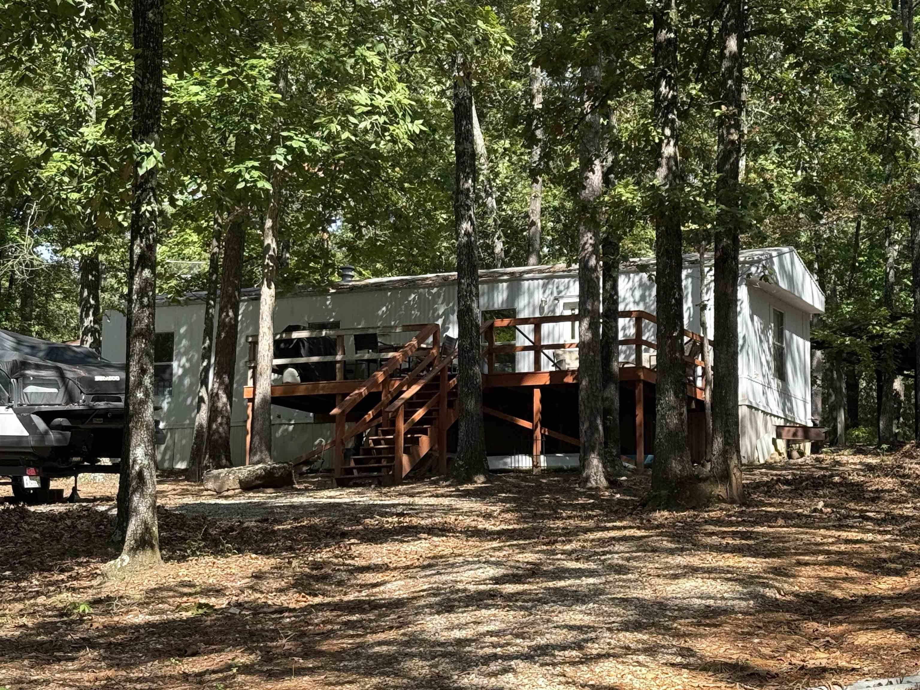 Take a look at this super cute home just across the road from Greers Ferry Lake! Located in the quiet community of Marvinsville you will have all the privacy you could want. Enjoy sitting out on your front deck watching all the wildlife with no traffic and a partial winter lake view. Home has been updated with new flooring, fresh paint, and new gas oven/cookstove. Nice circle drive with plenty of parking, new storage building and small carport to store your lake toys or ATV. Give us a call today!