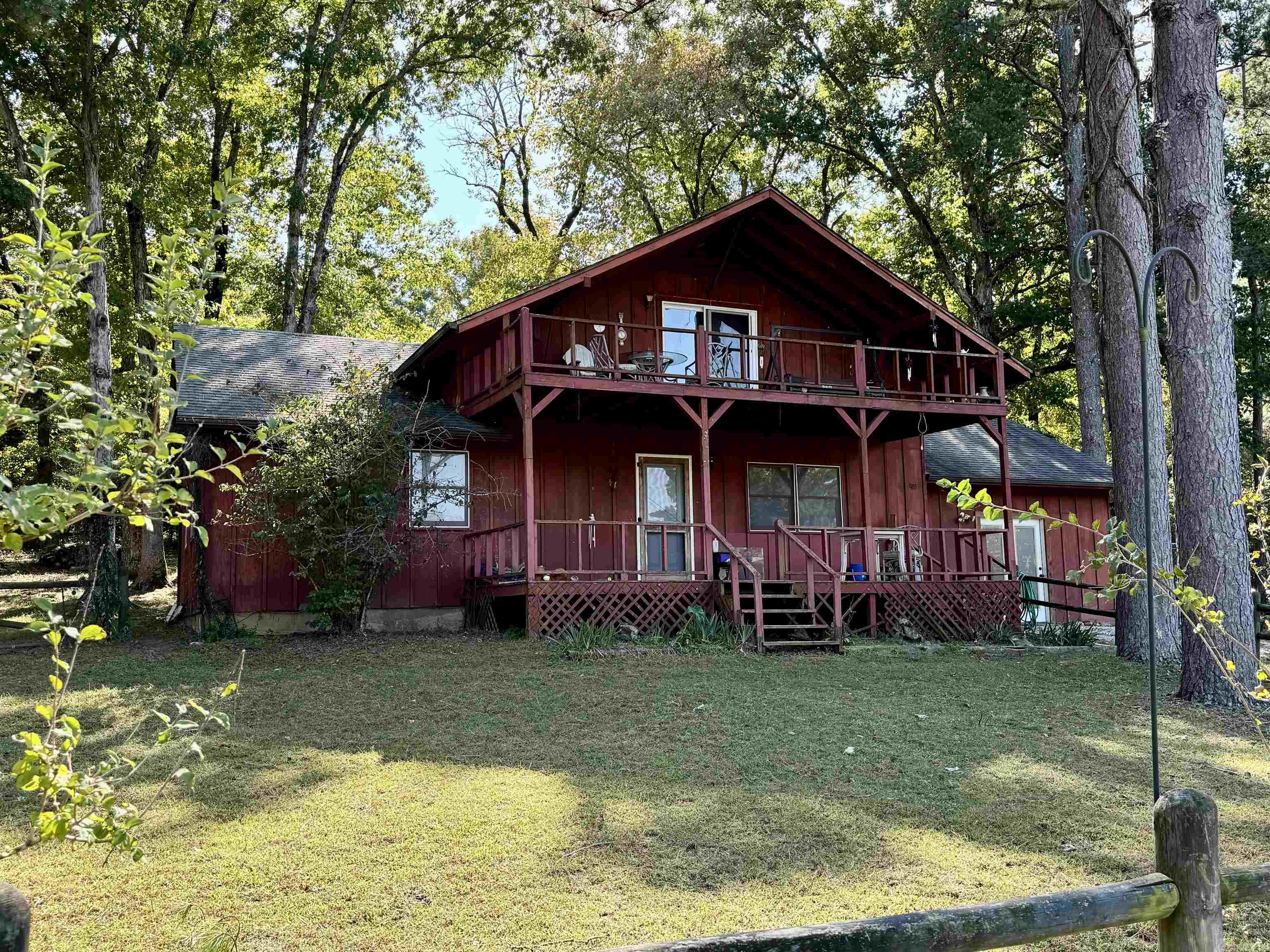 COUNTRY HOME WITH GUEST HOUSE ON 20 ACRES IN THE OZARKS!!  The Main house has been completely remodeled creating an inviting atmosphere, featuring a spacious kitchen that's open to the dining area. The living area has a large native stone wood burning fireplace complemented by beautiful wood walls. The main floor has two bedroom and a full bathroom. Upstairs is a large bedroom, siting area, and full bathroom with a walk in shower, as well as a private balcony overlooking the fields & pond. The guest house is a log home with a large front porch featuring 1 bedroom, 1 bathroom and has an open floor plan! The property is the perfect place for horses or livestock with a fenced in area, large barn, and pond! Property offers seclusion and privacy being at the end of a road! Call for more details!